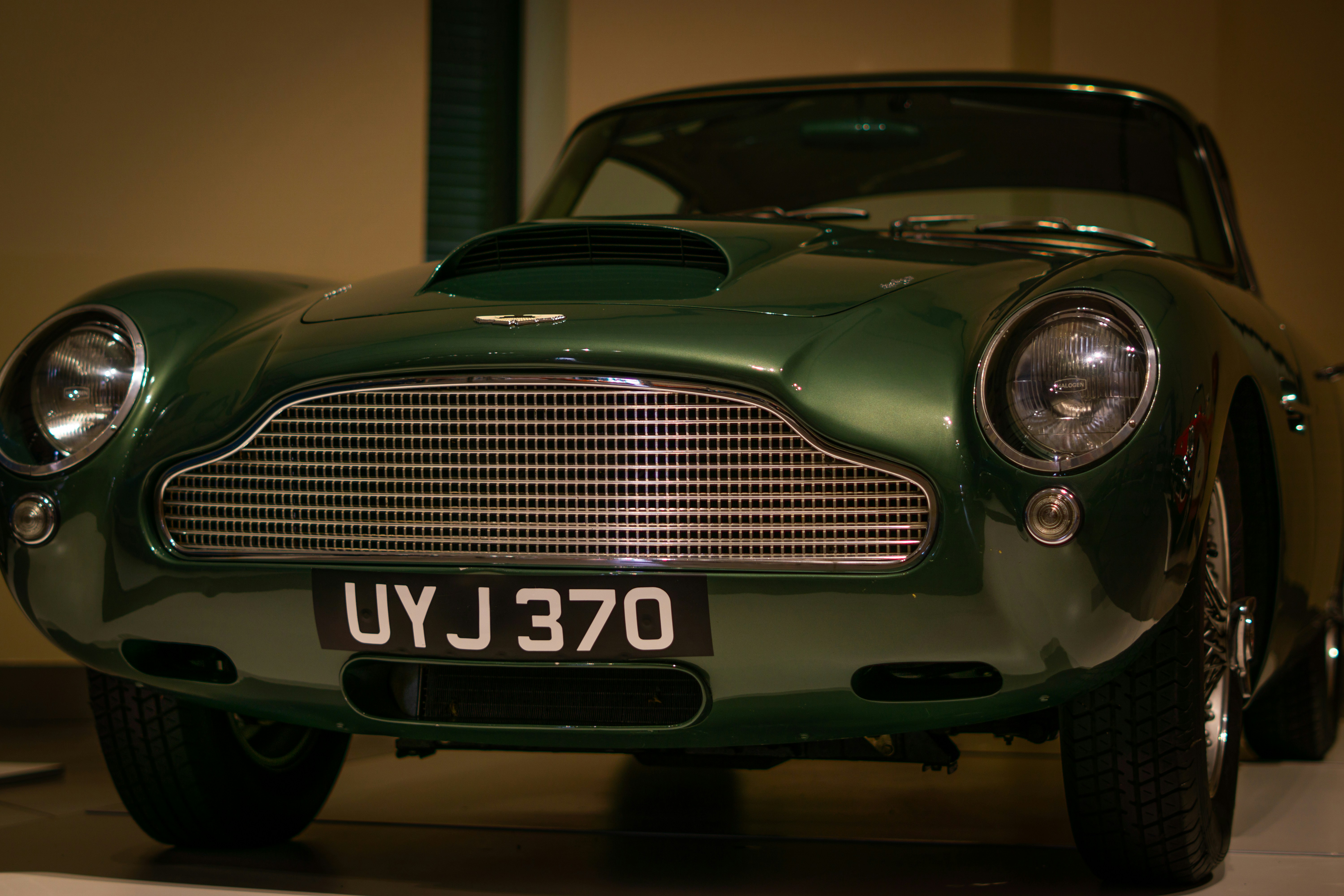 A green sports car parked in a garage
