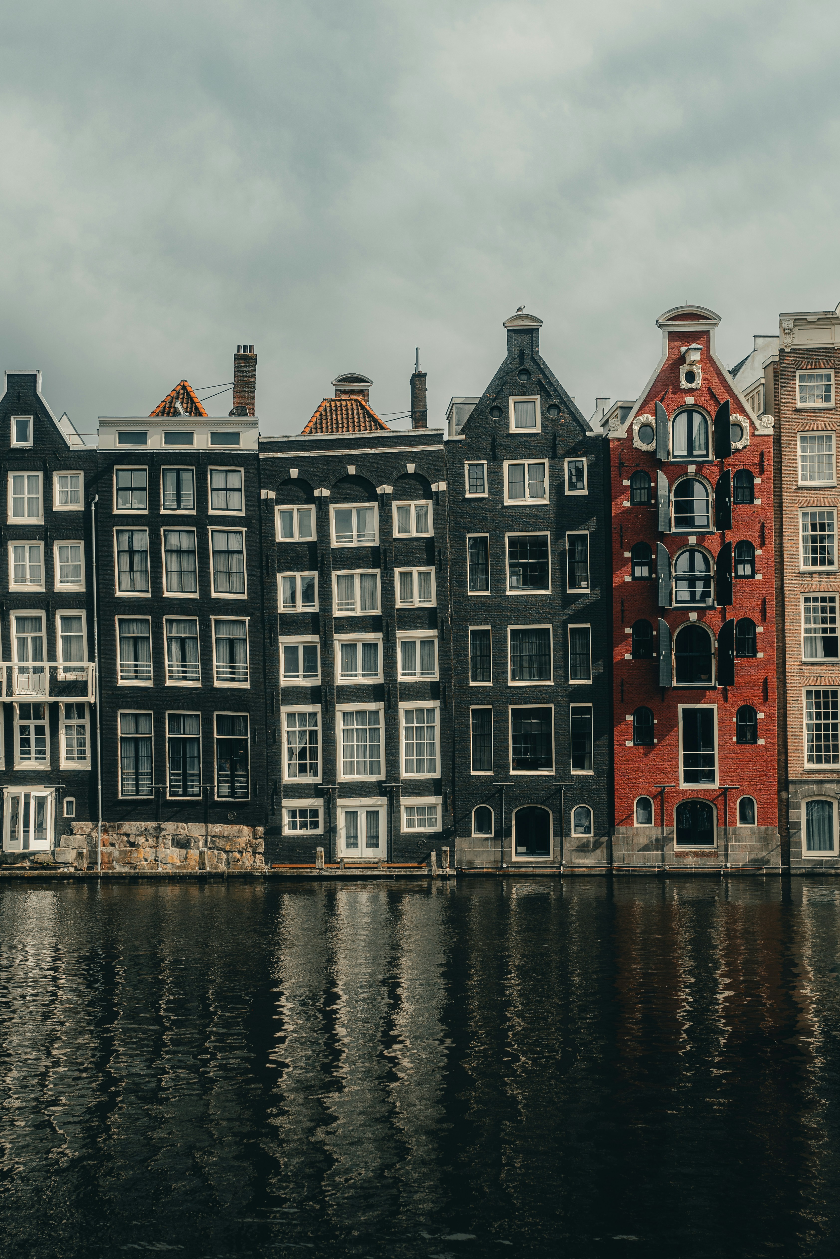 A row of buildings next to a body of water