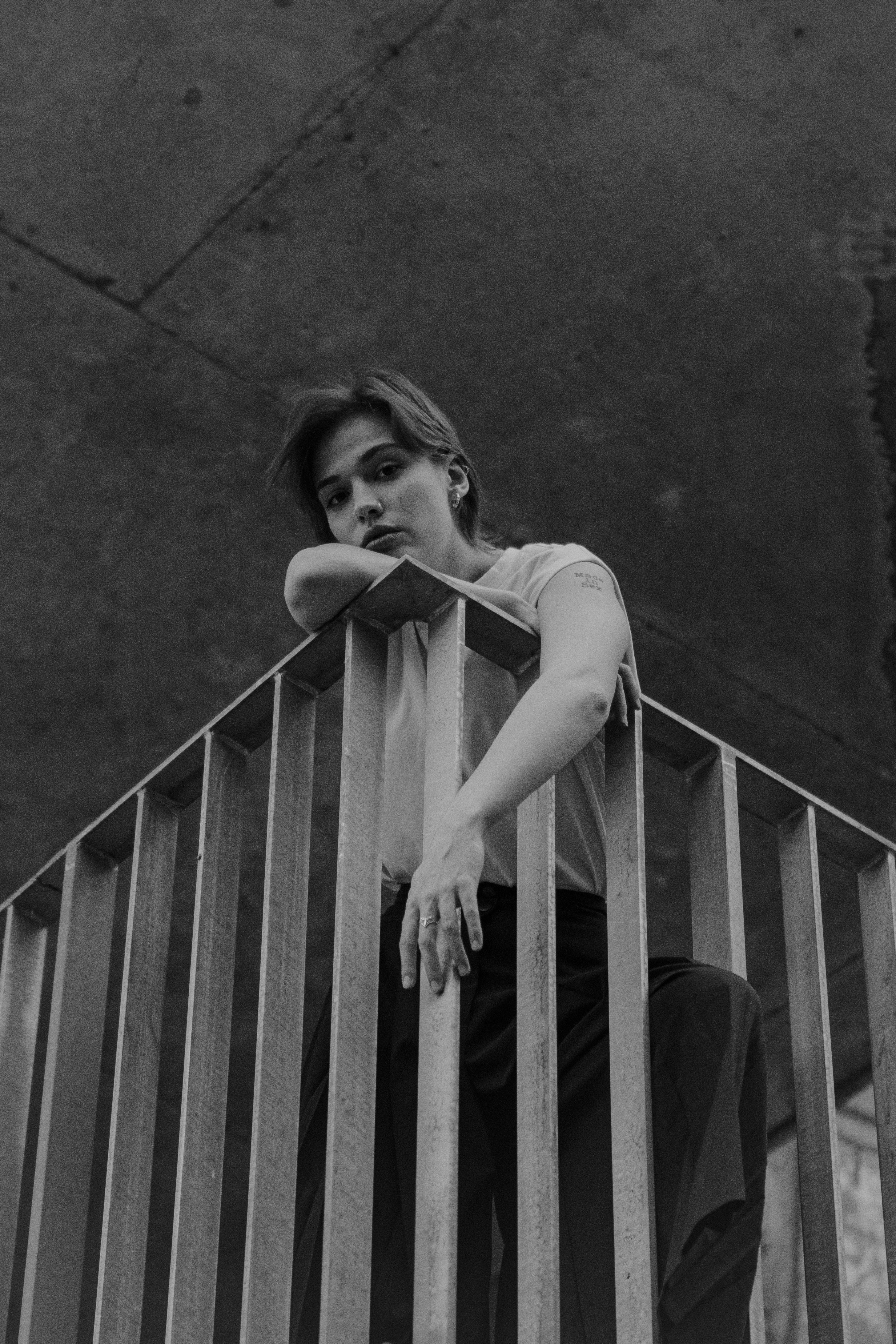 A woman leaning on a railing with her hands on her hips