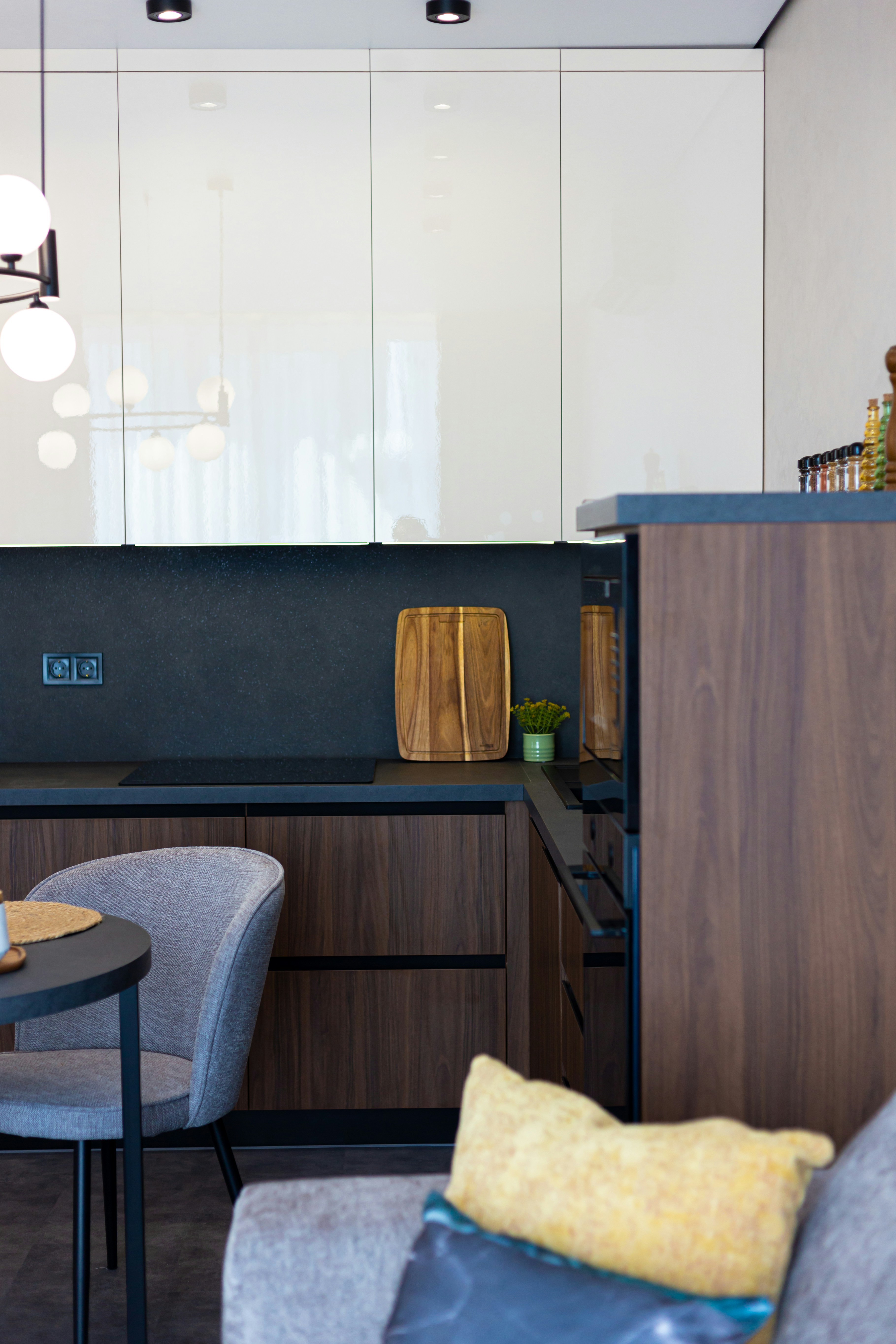 A kitchen with a table, chairs, and cabinets