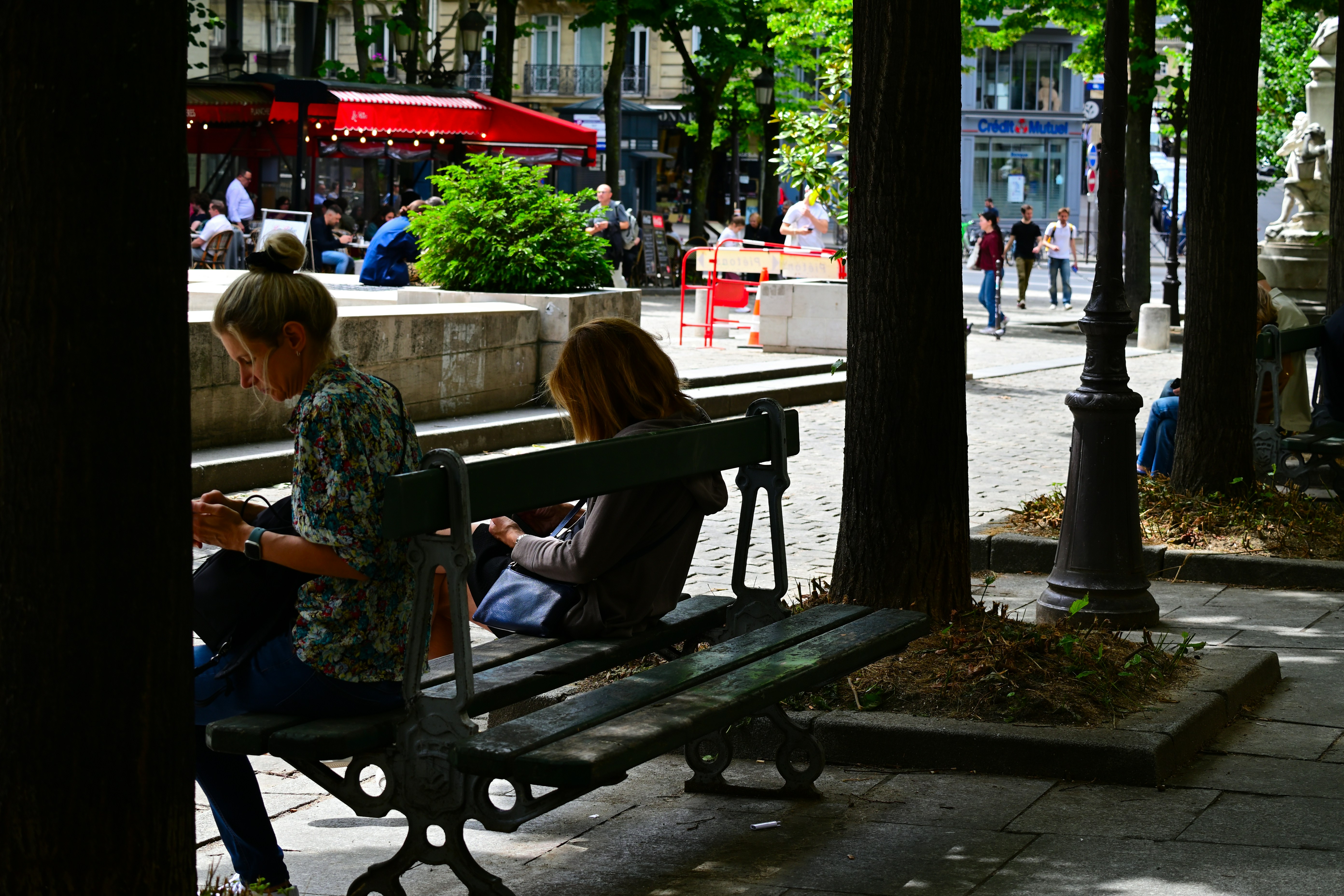 A couple of people sitting on a bench