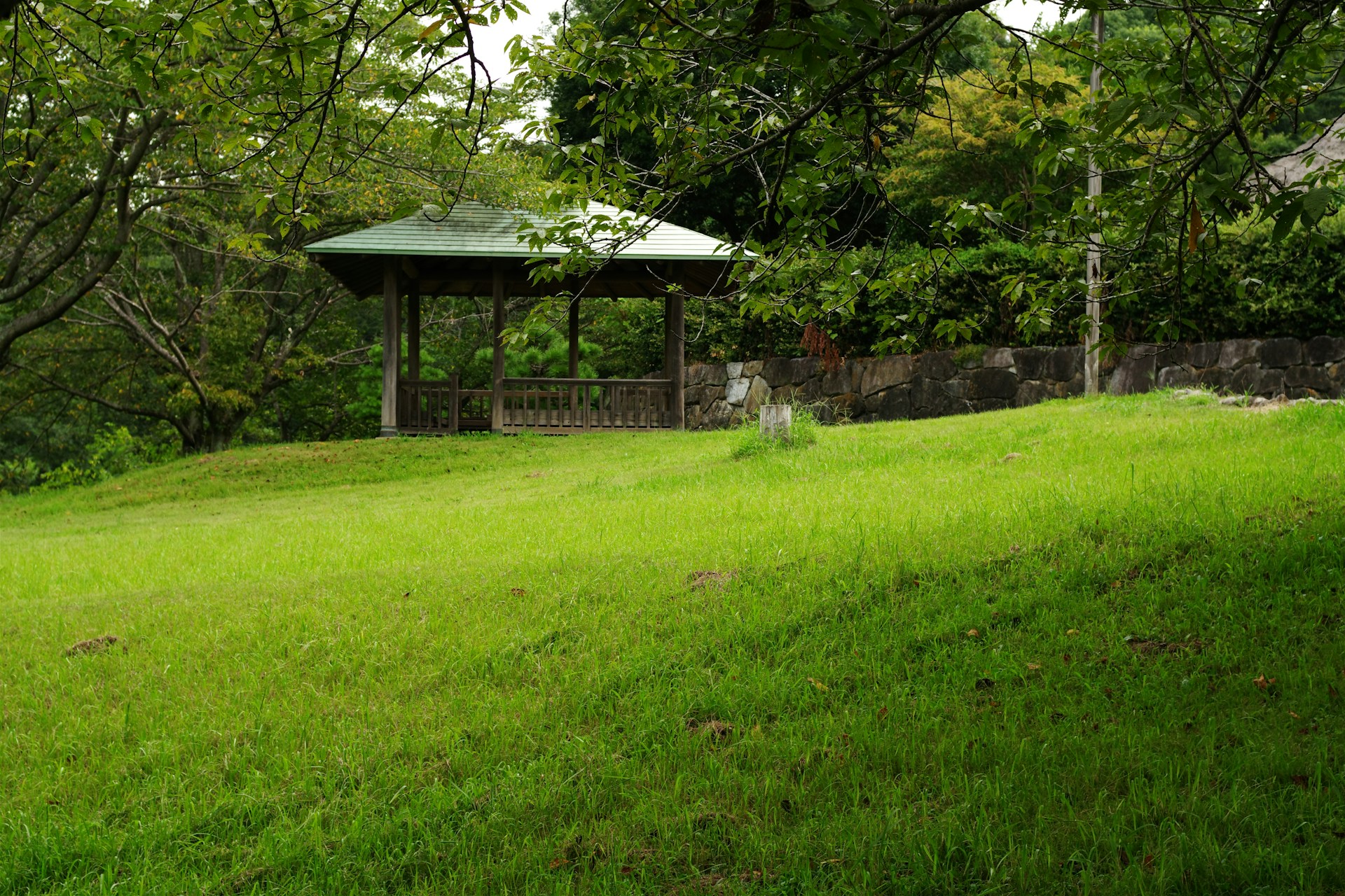 A gazebo in the middle of a grassy field