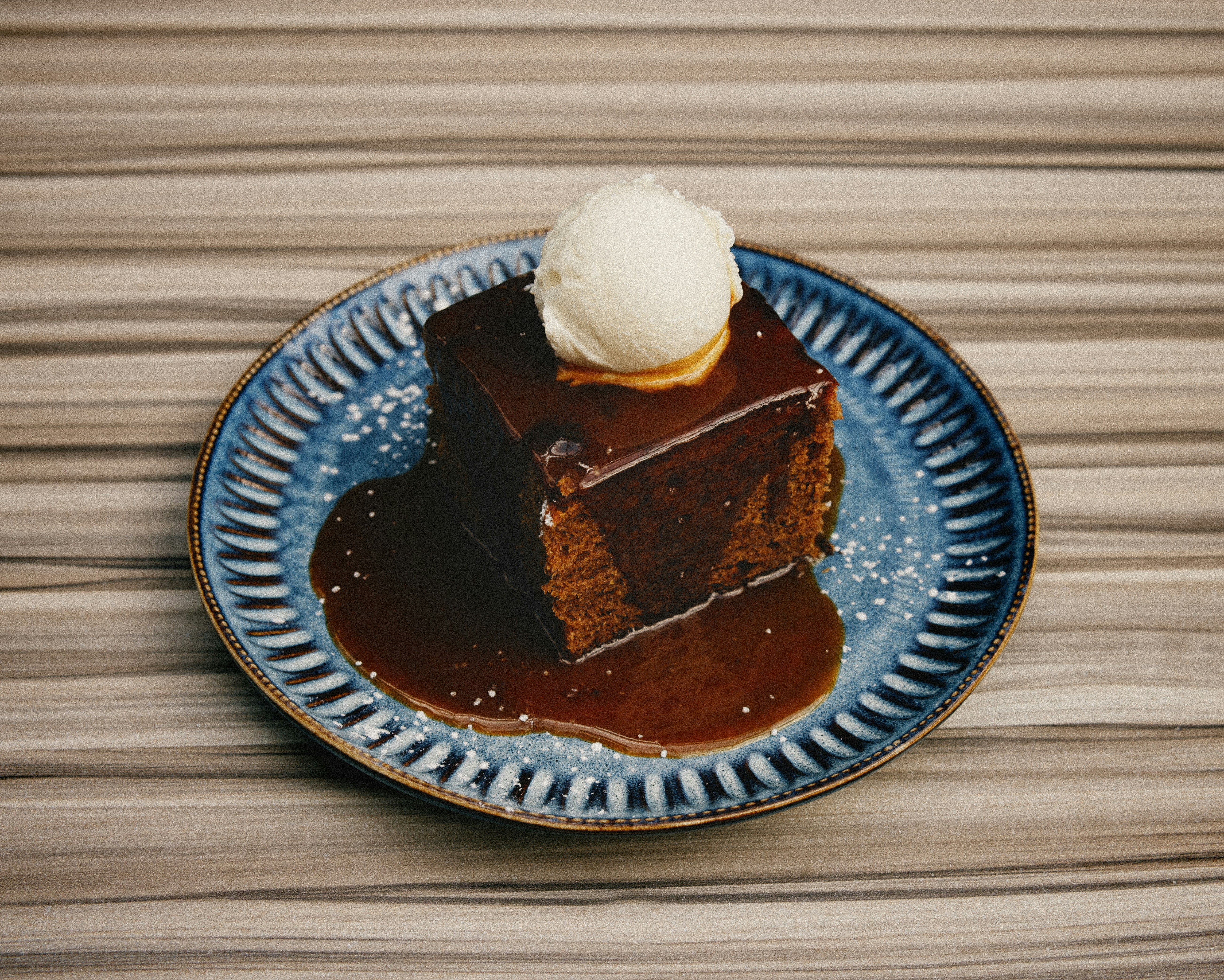 A piece of chocolate cake on a blue plate
