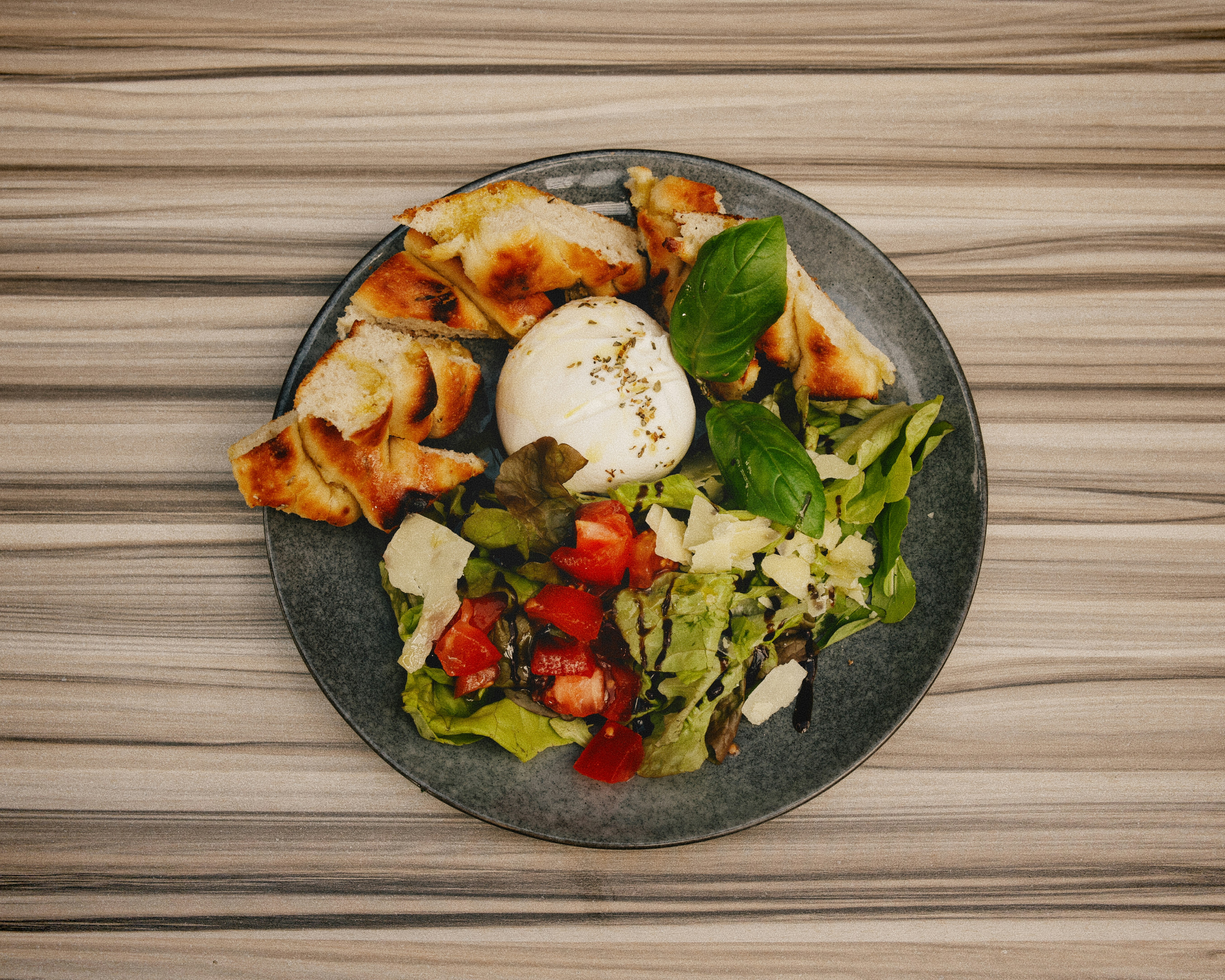 A plate of food on a wooden table