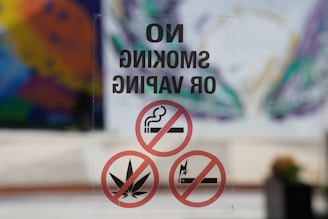 A no smoking or vaping sign on a glass door