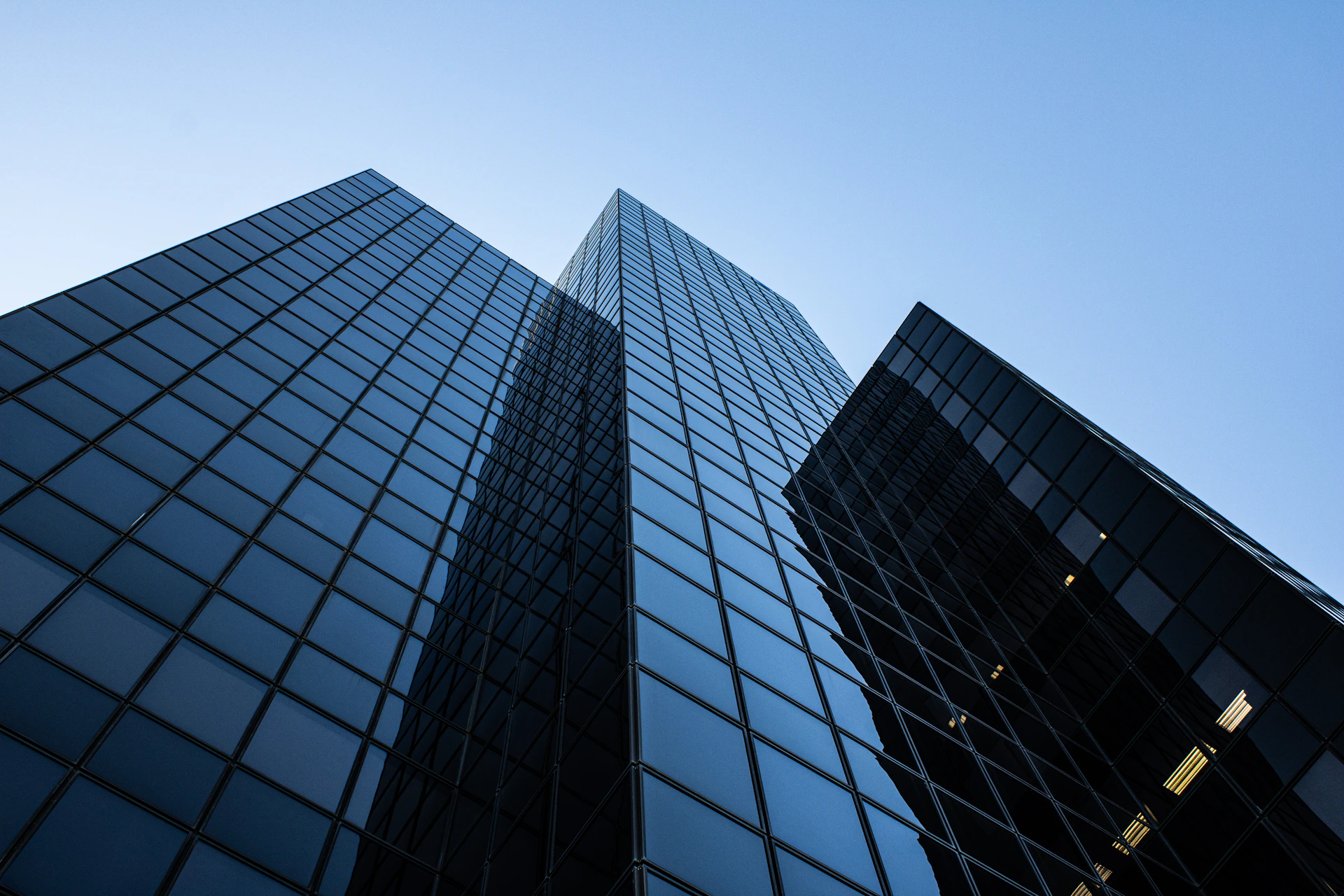 Two tall buildings with a blue sky in the background