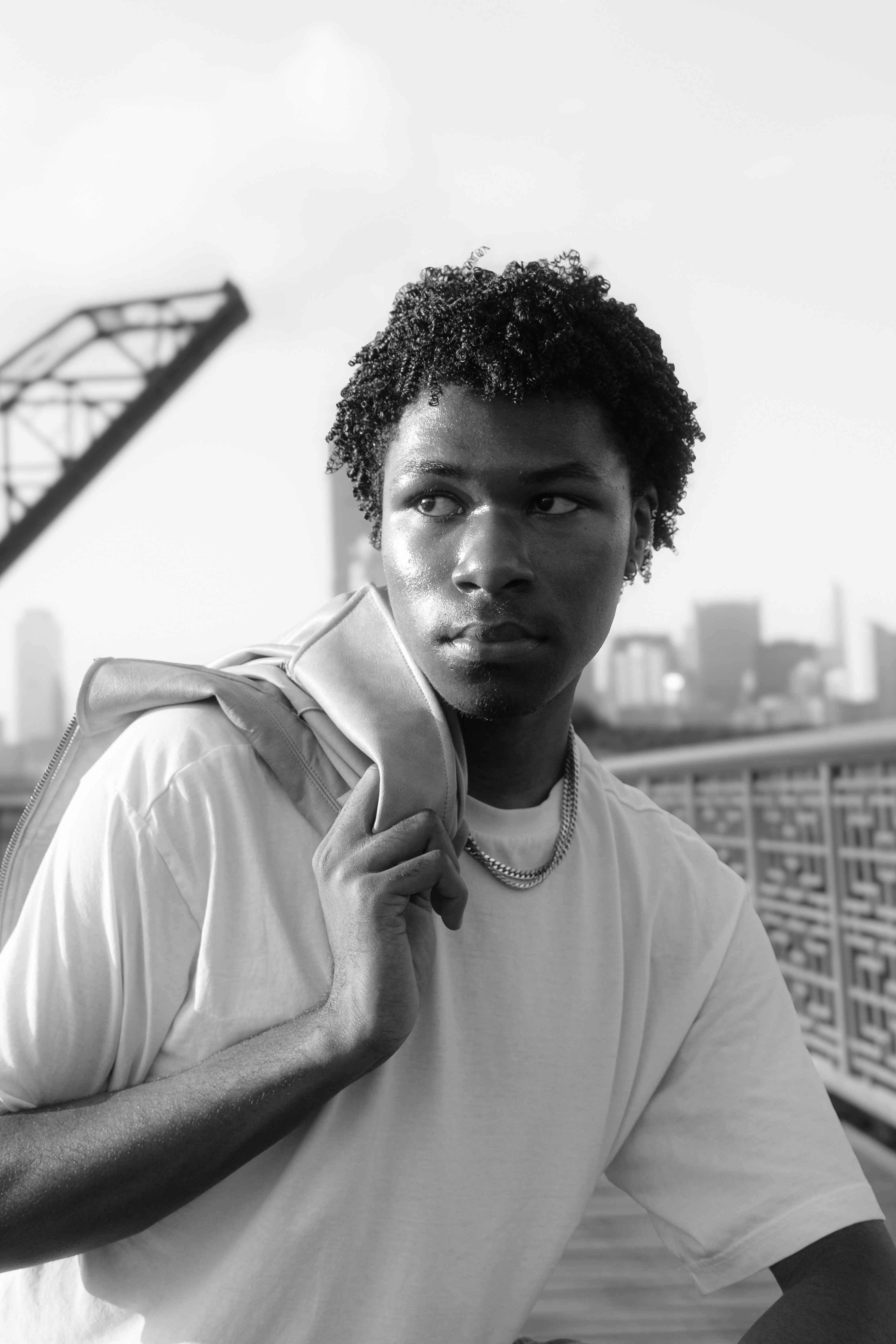 A man standing on top of a bridge next to a tall building