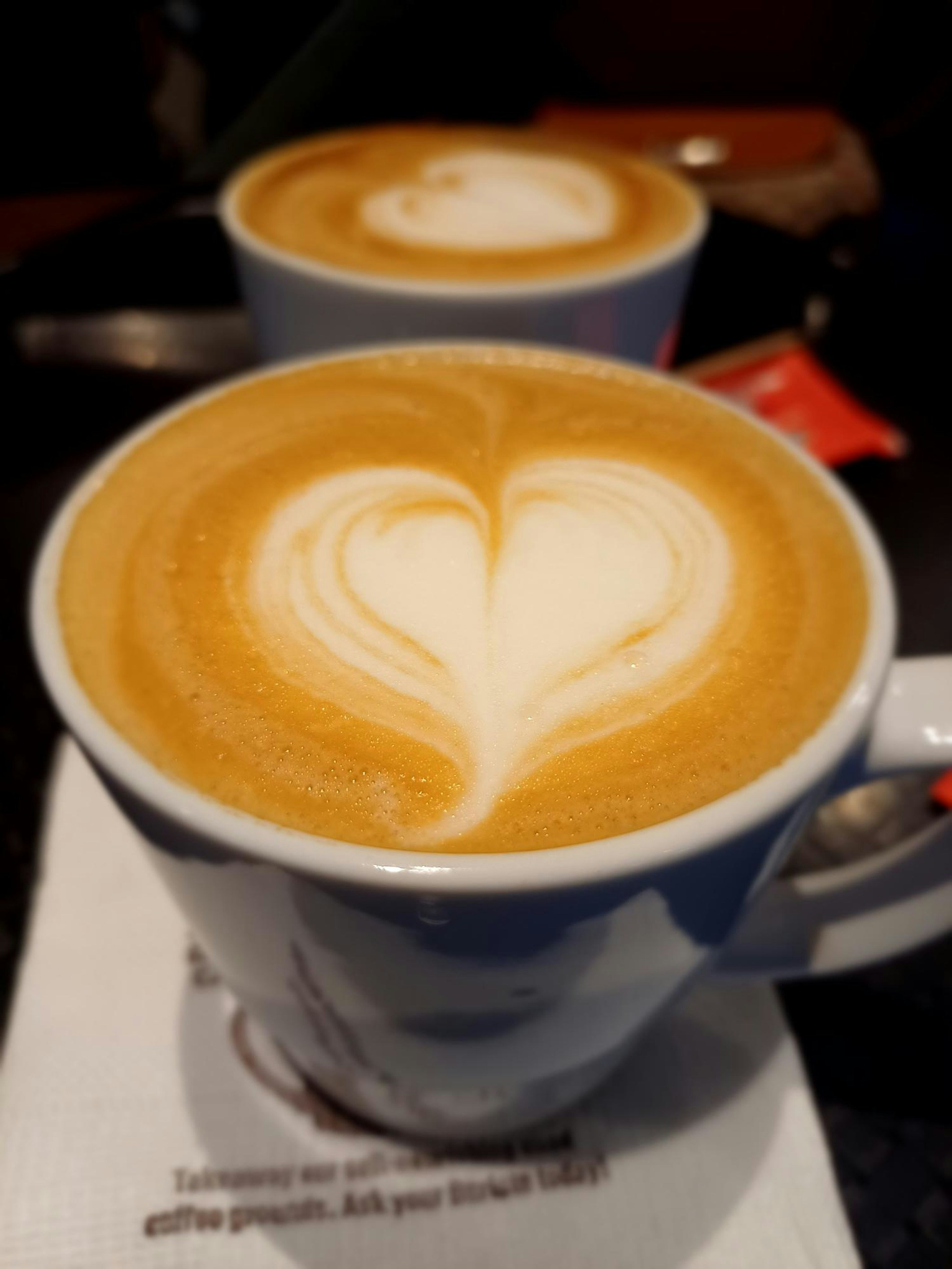 A couple of cups of coffee on a table