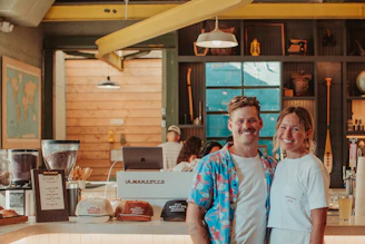 A man and a woman standing in a kitchen