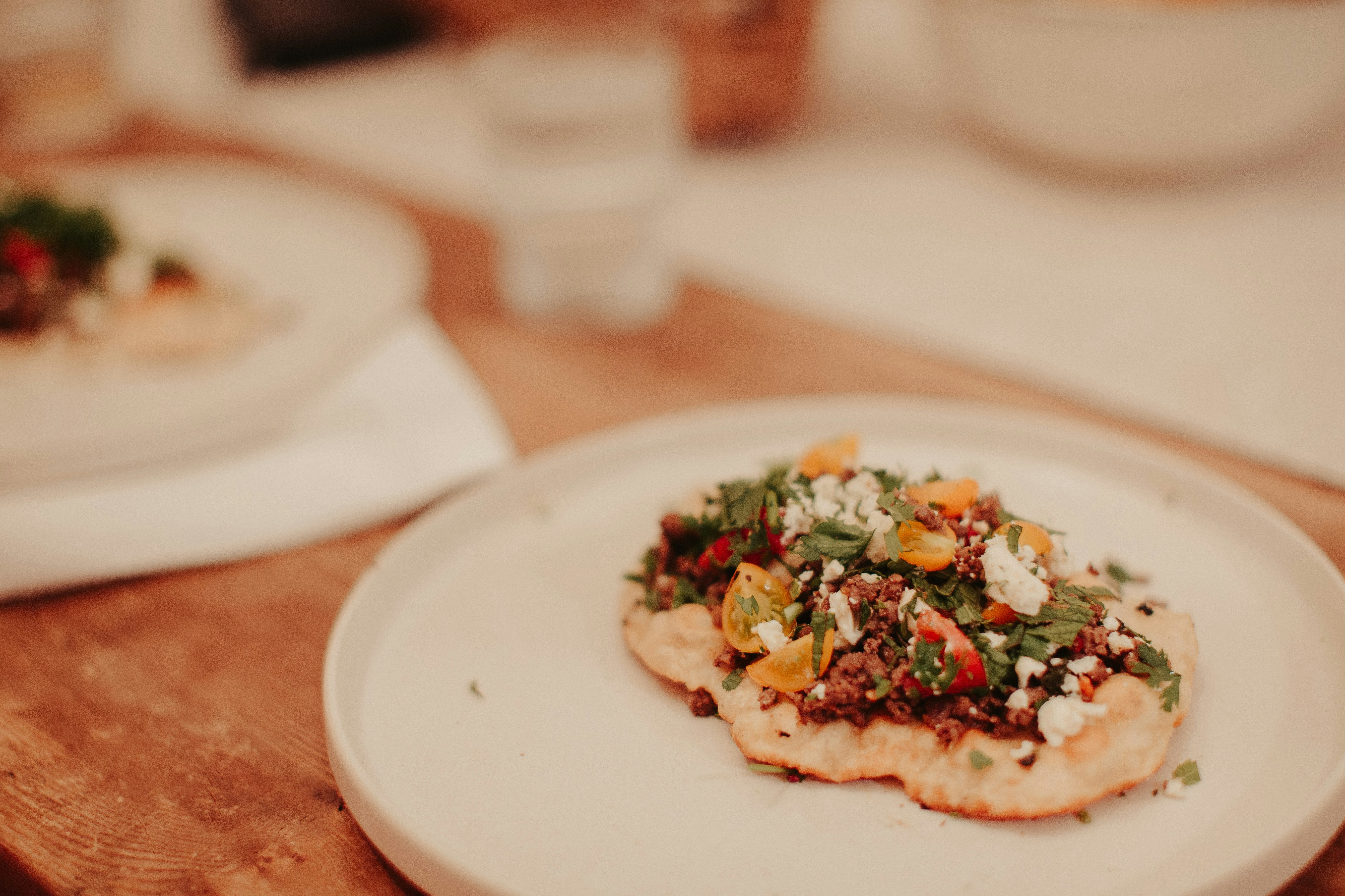 Plated dish on a white plate on a wooden table