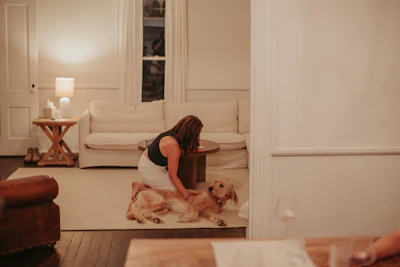 A woman sitting on the floor with her dog