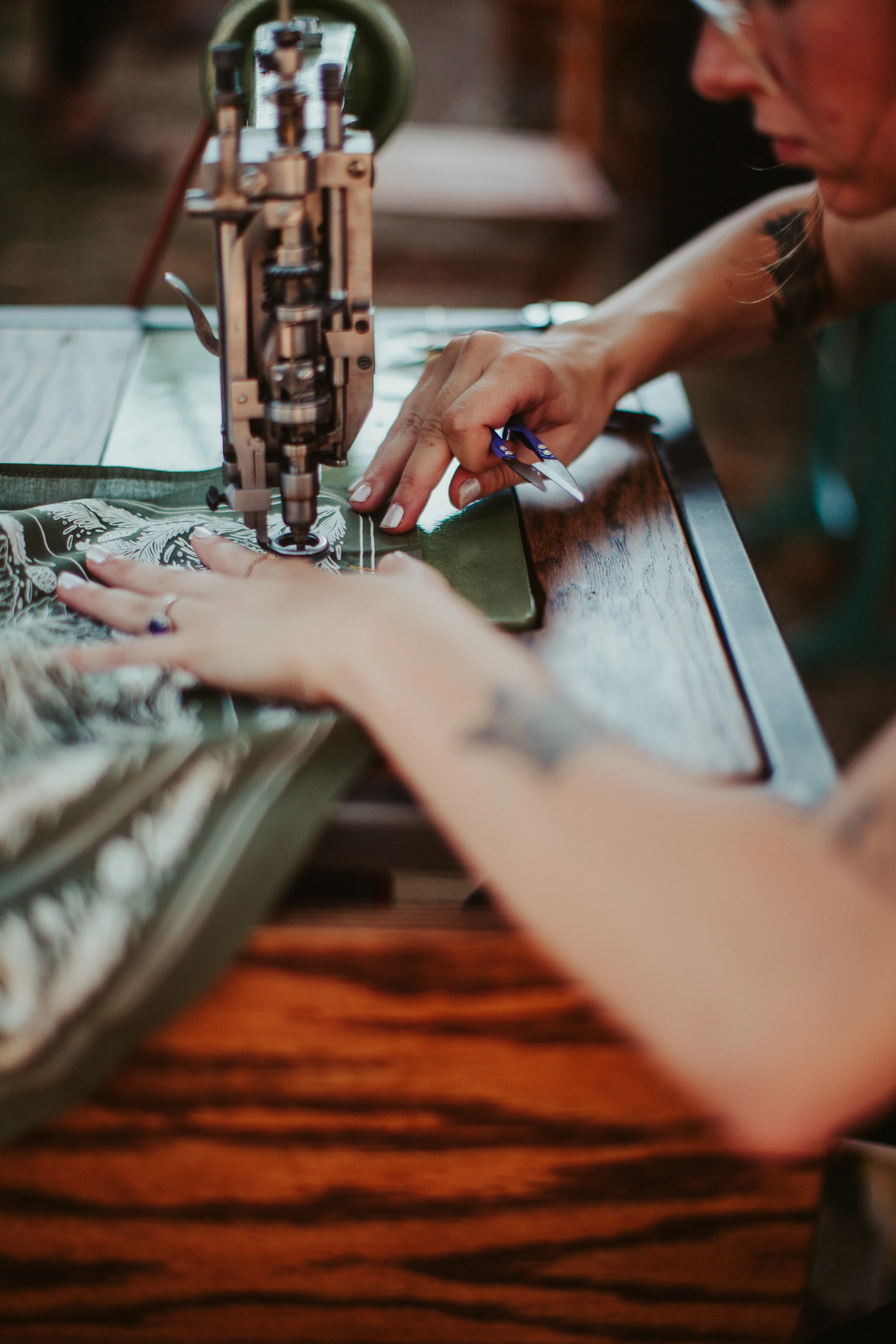 A woman is working on a sewing machine