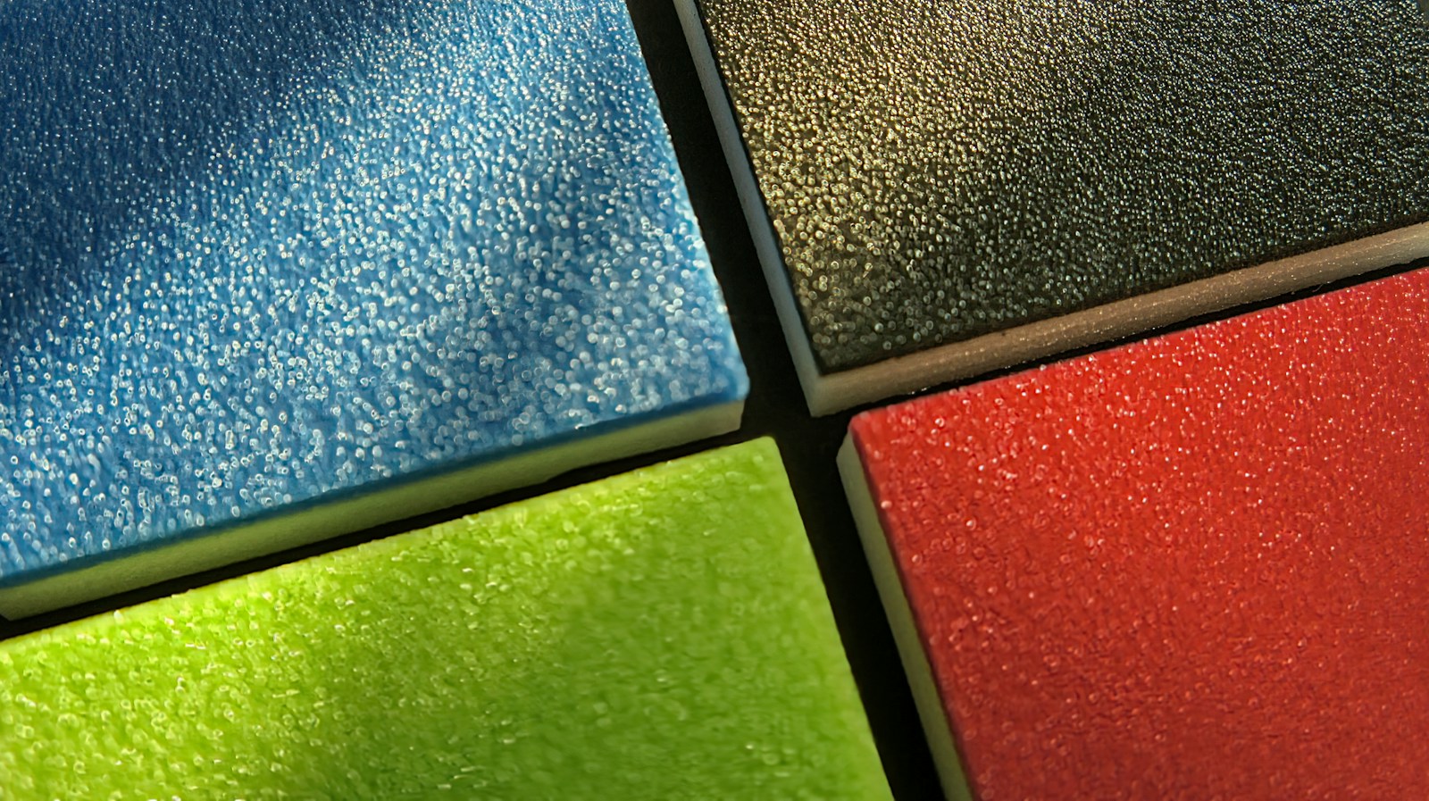 Interlocking rubber safety tiles in blue, olive, red and green