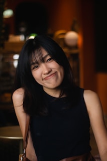 A woman sitting at a table smiling for the camera