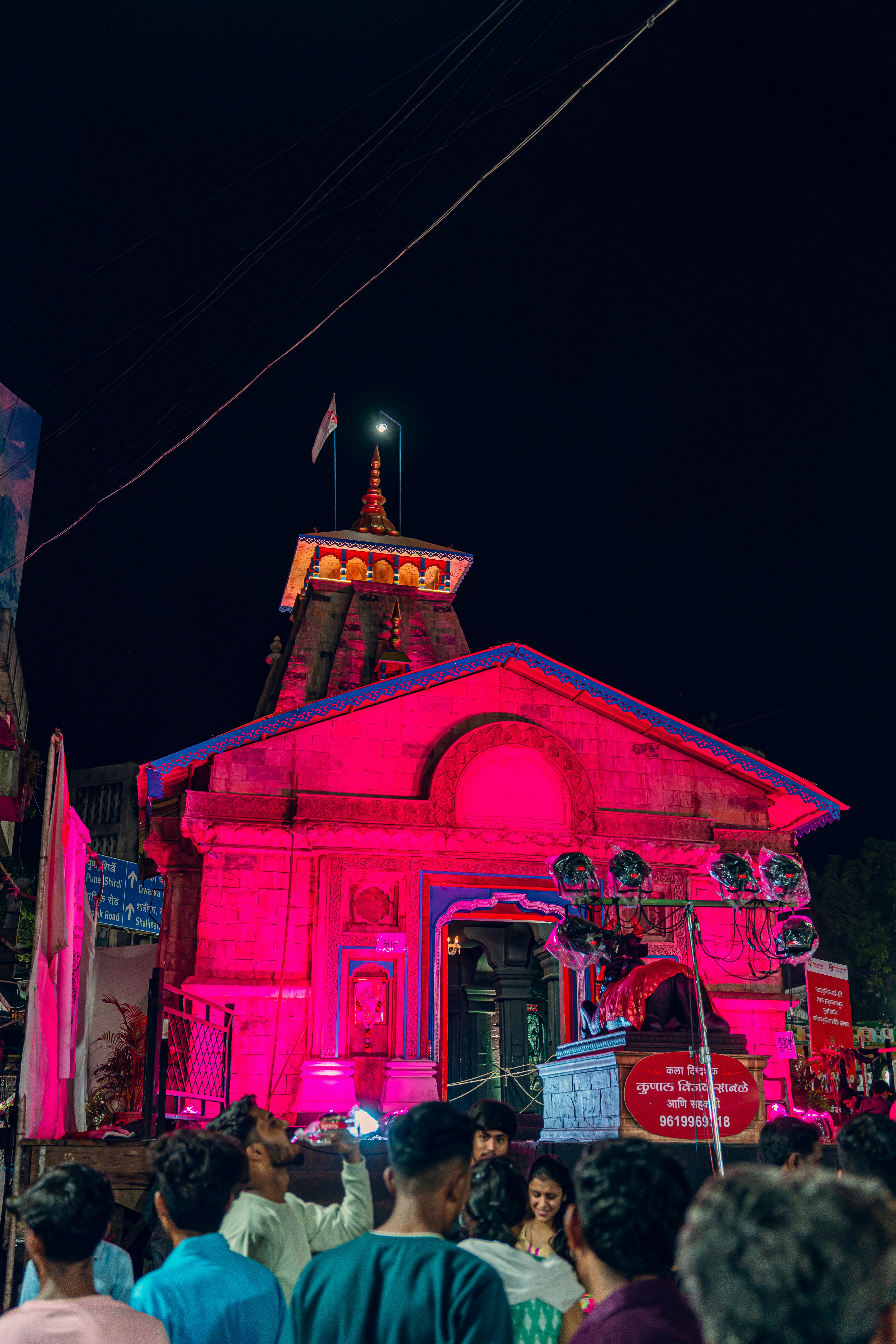 A group of people standing in front of a building