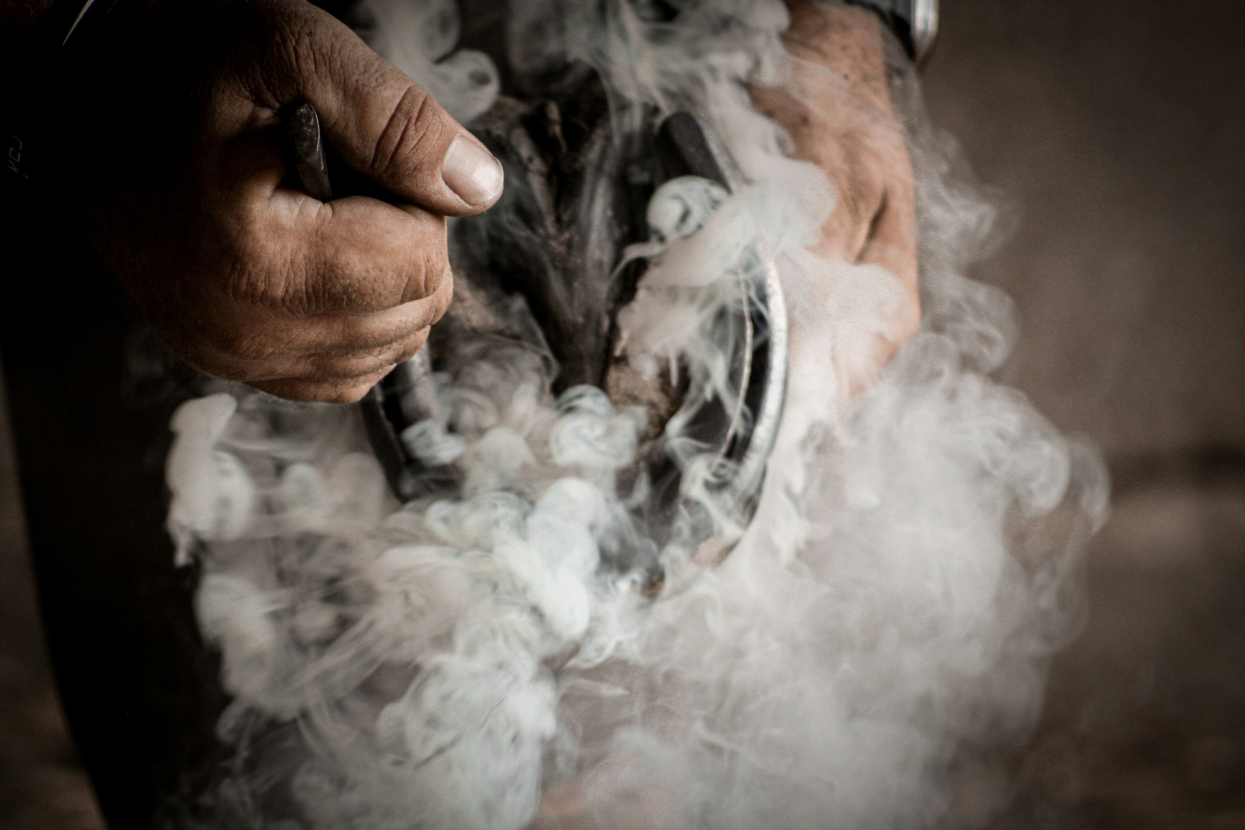 A person holding a cigarette in their hands