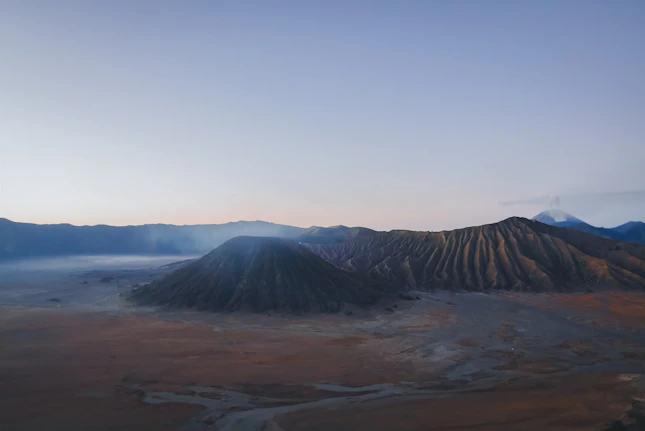An aerial view of a mountain range in the distance