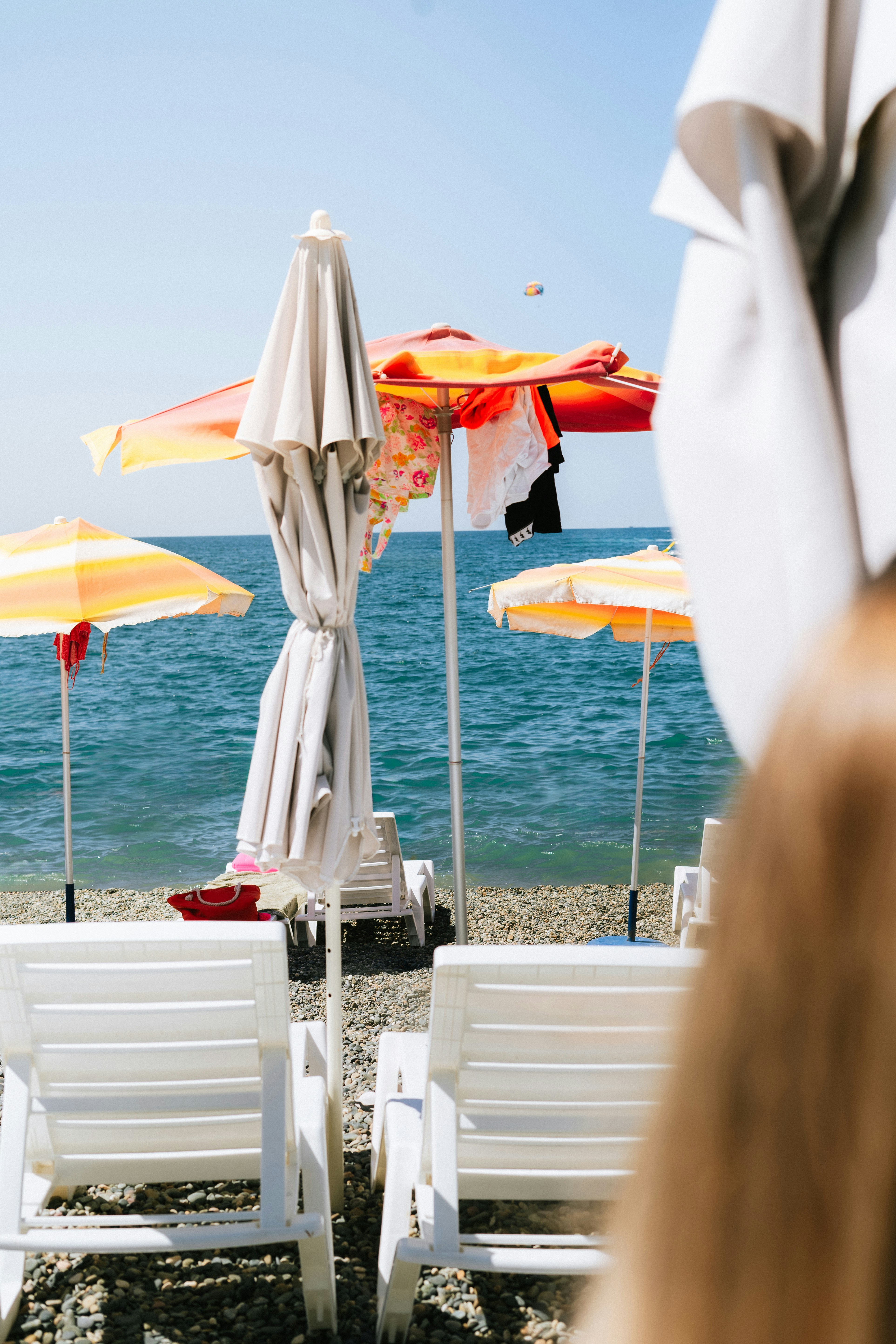 A row of beach chairs sitting on top of a sandy beach