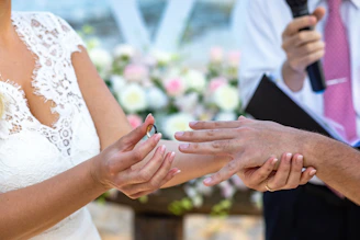 A man and a woman holding hands during a wedding ceremony