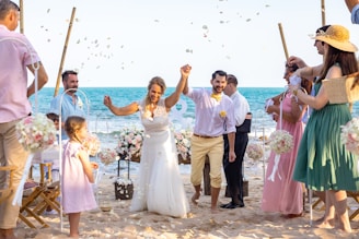 A group of people standing on top of a beach