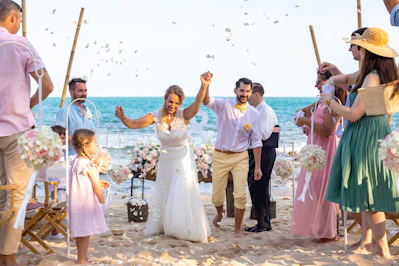 A group of people standing on top of a beach