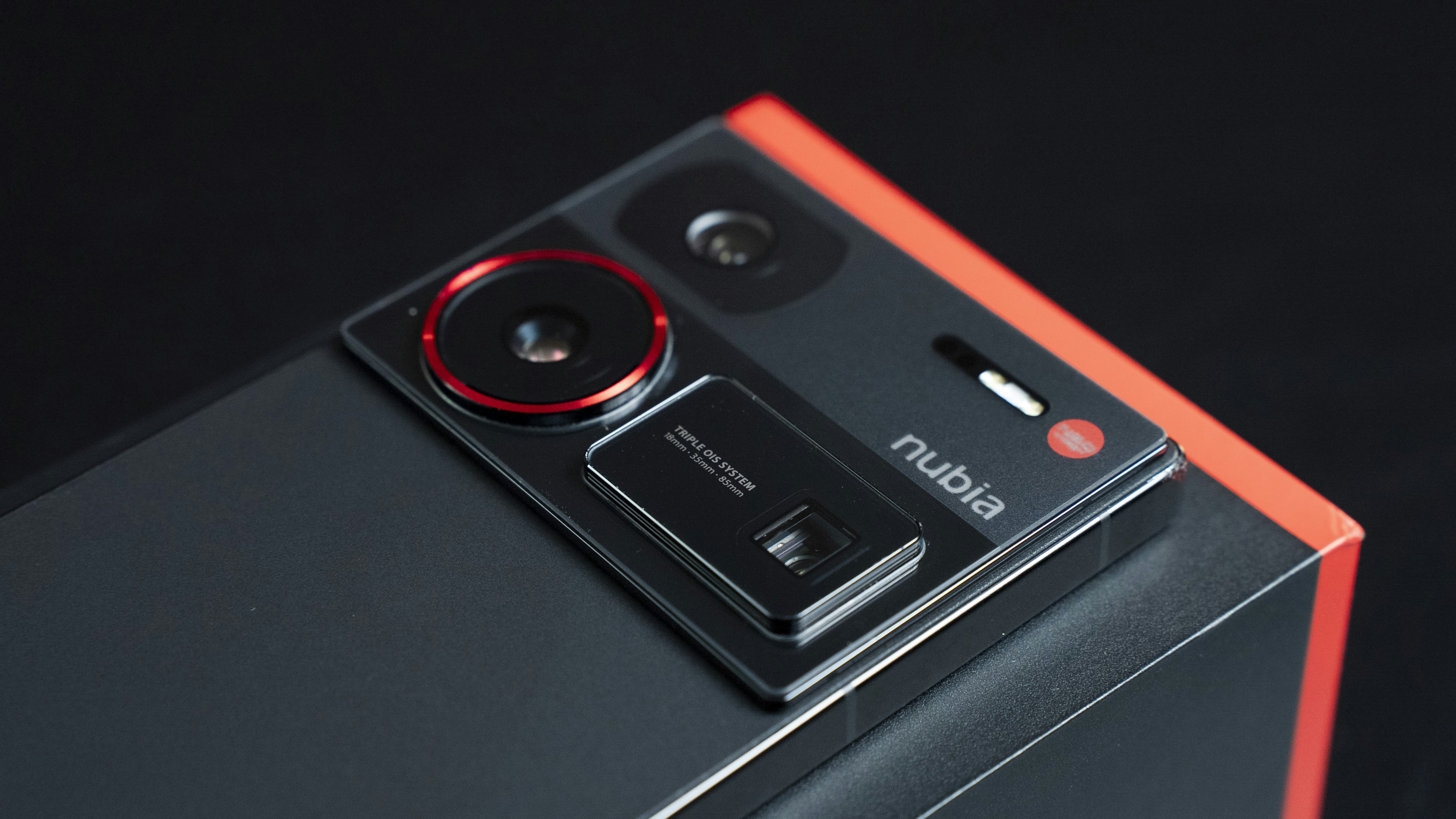 A close up of a cell phone on a black surface