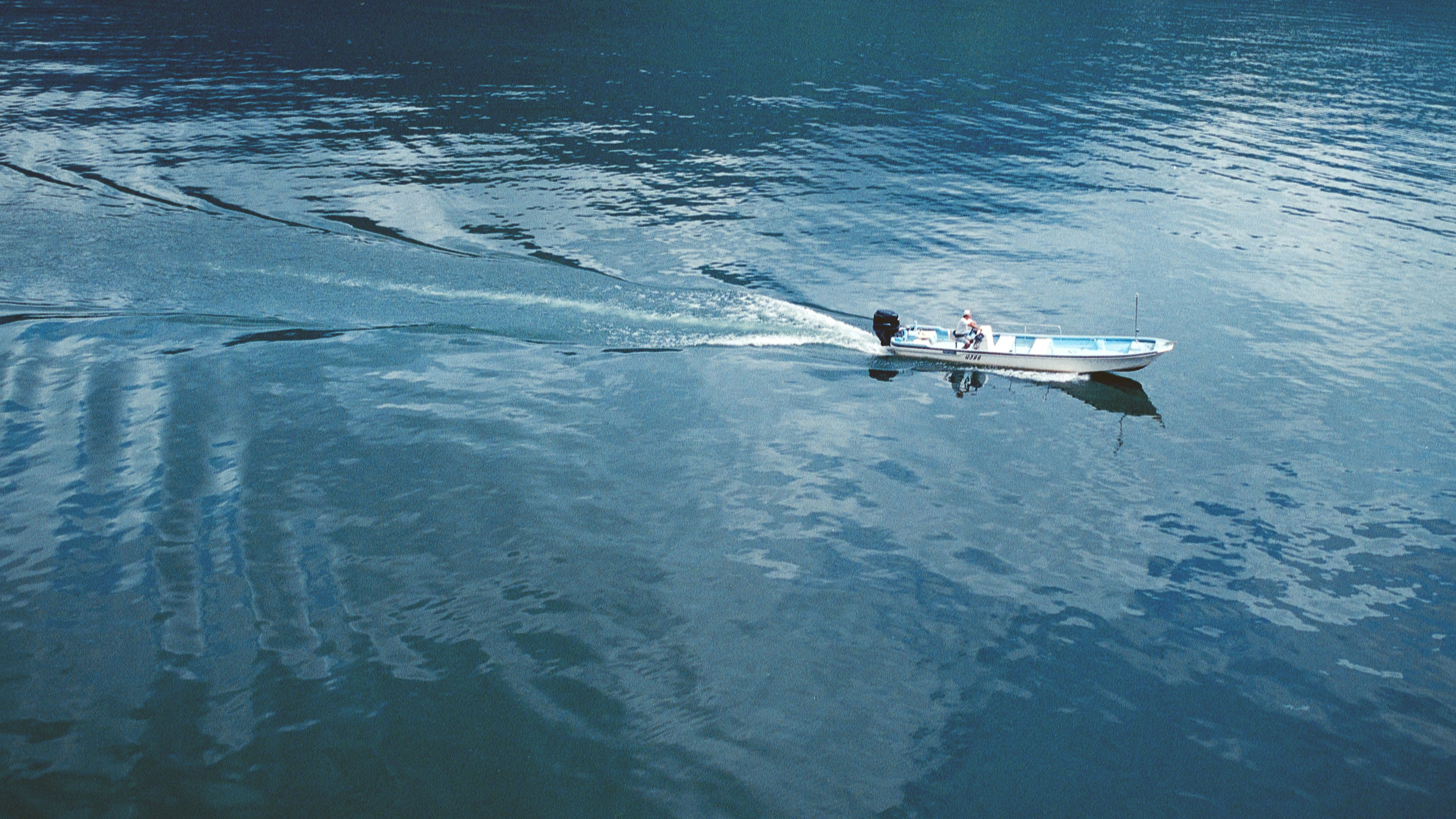 A person rowing a boat on a body of water
