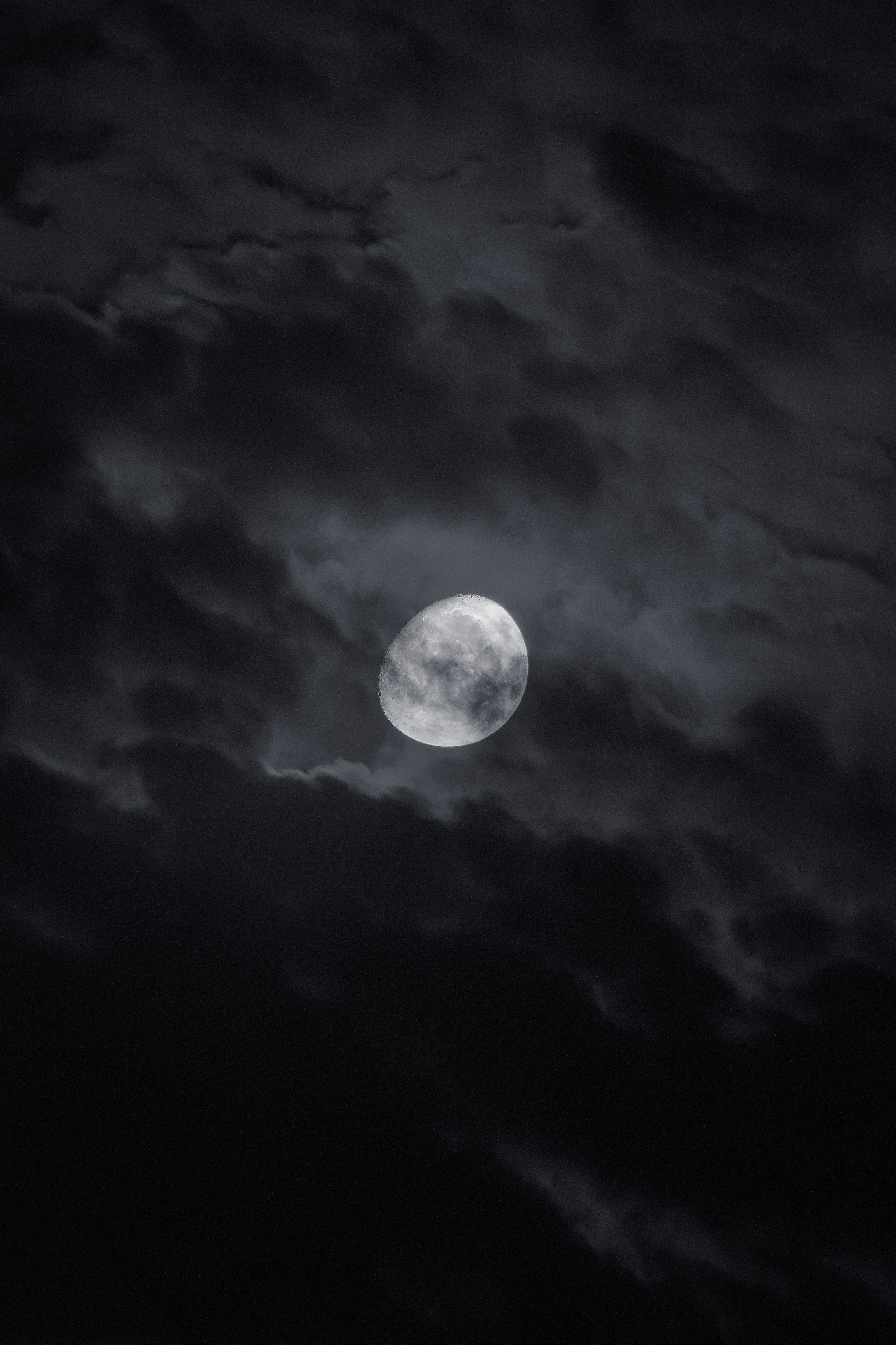 A full moon in a cloudy sky with dark clouds - Free Photo on Unsplash