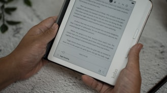 A person holding a tablet with a book on it