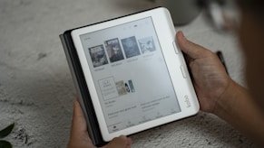 A person holding a tablet with a page on it