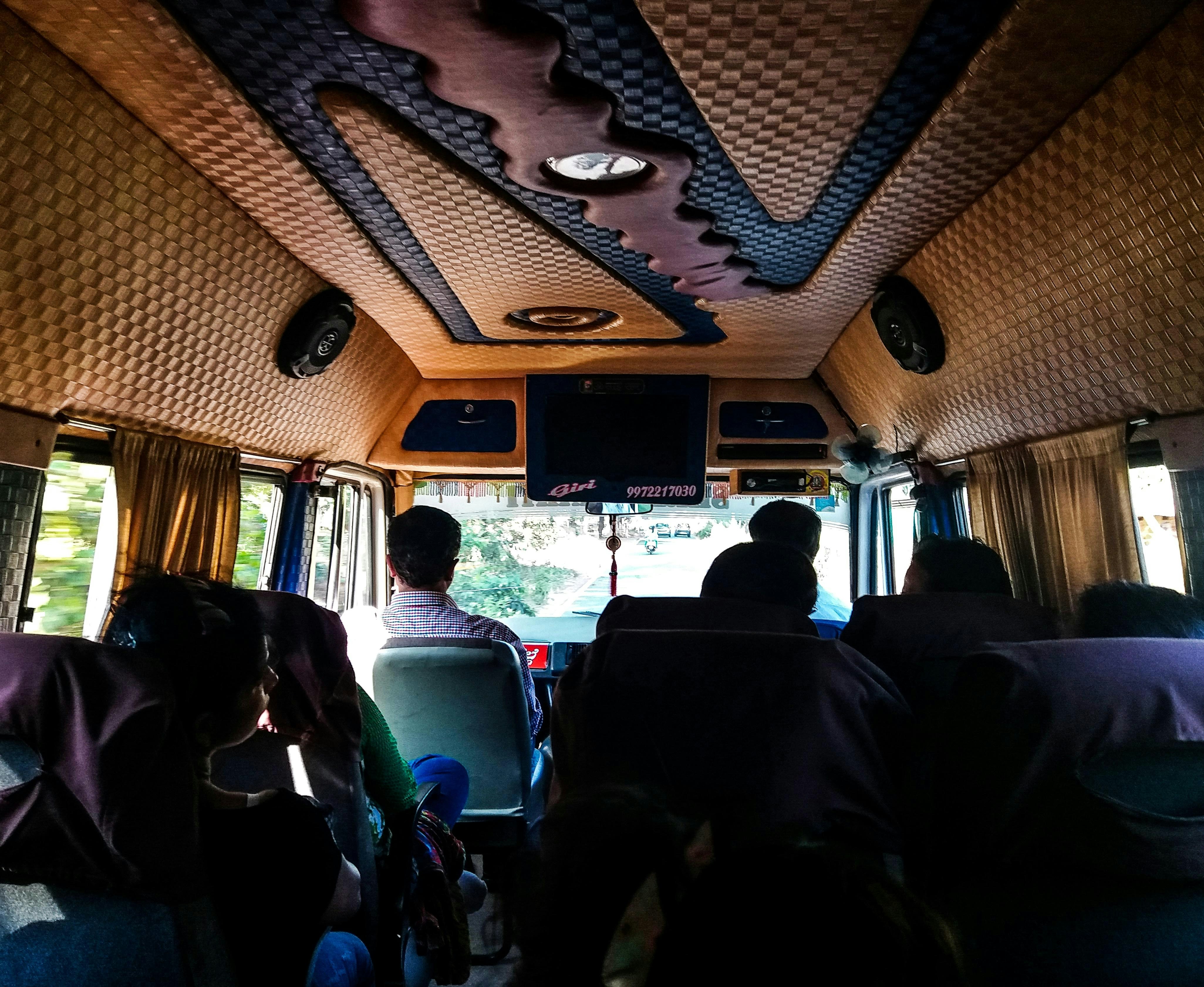A group of people sitting inside of a bus