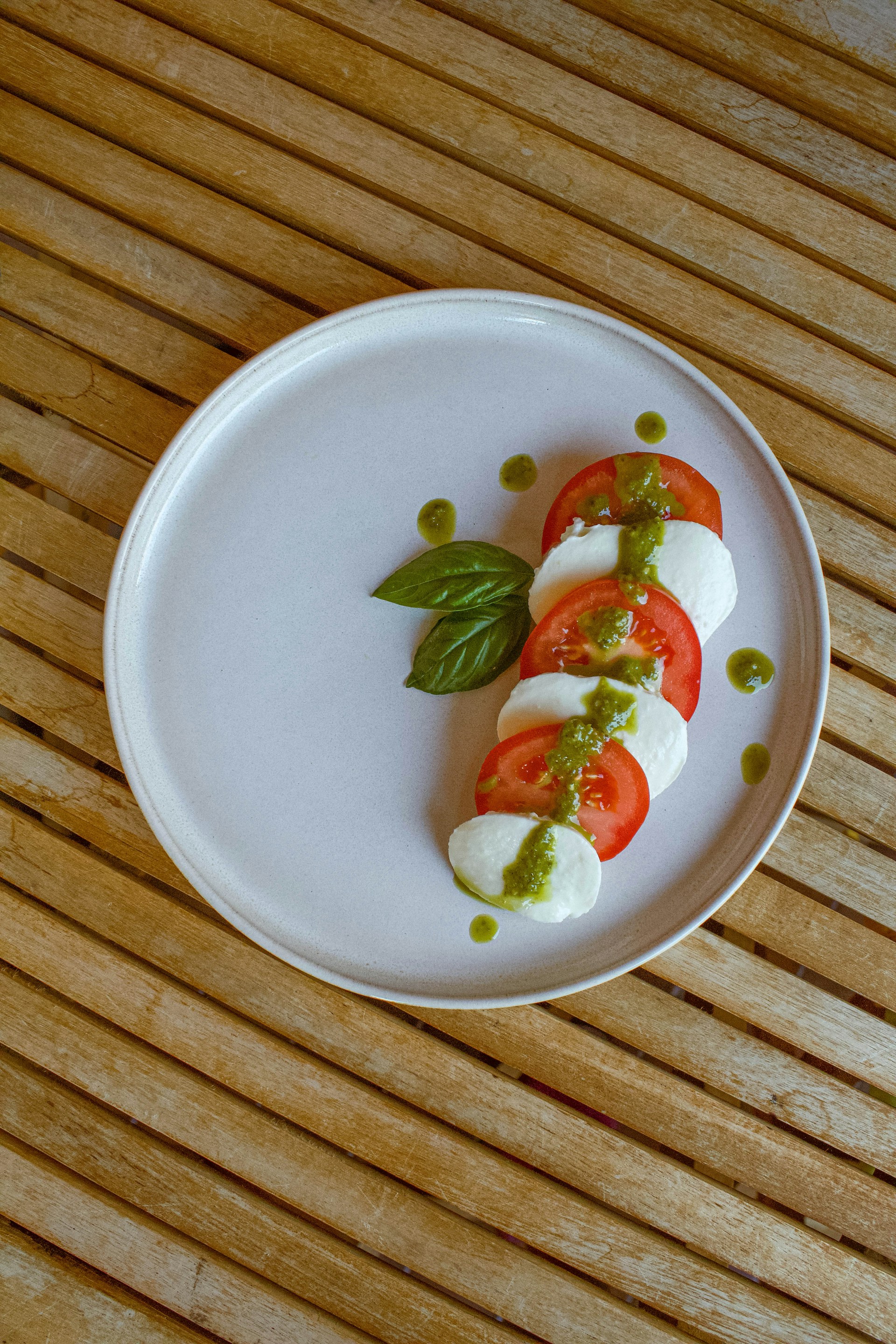 A white plate topped with food on top of a wooden table