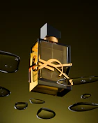 A bottle of perfume floating in the air next to a pair of scissors