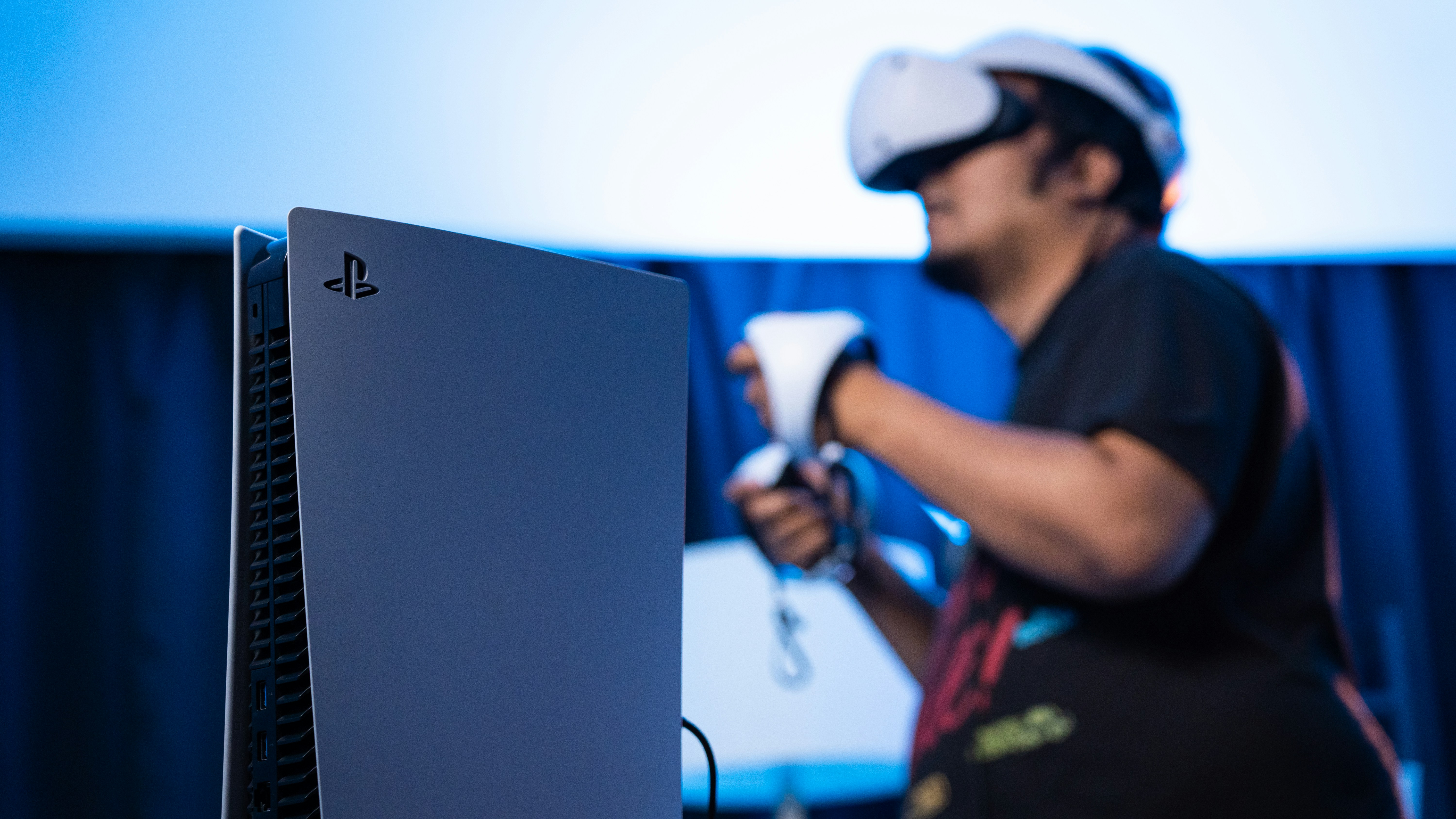 A man is playing a video game on a laptop