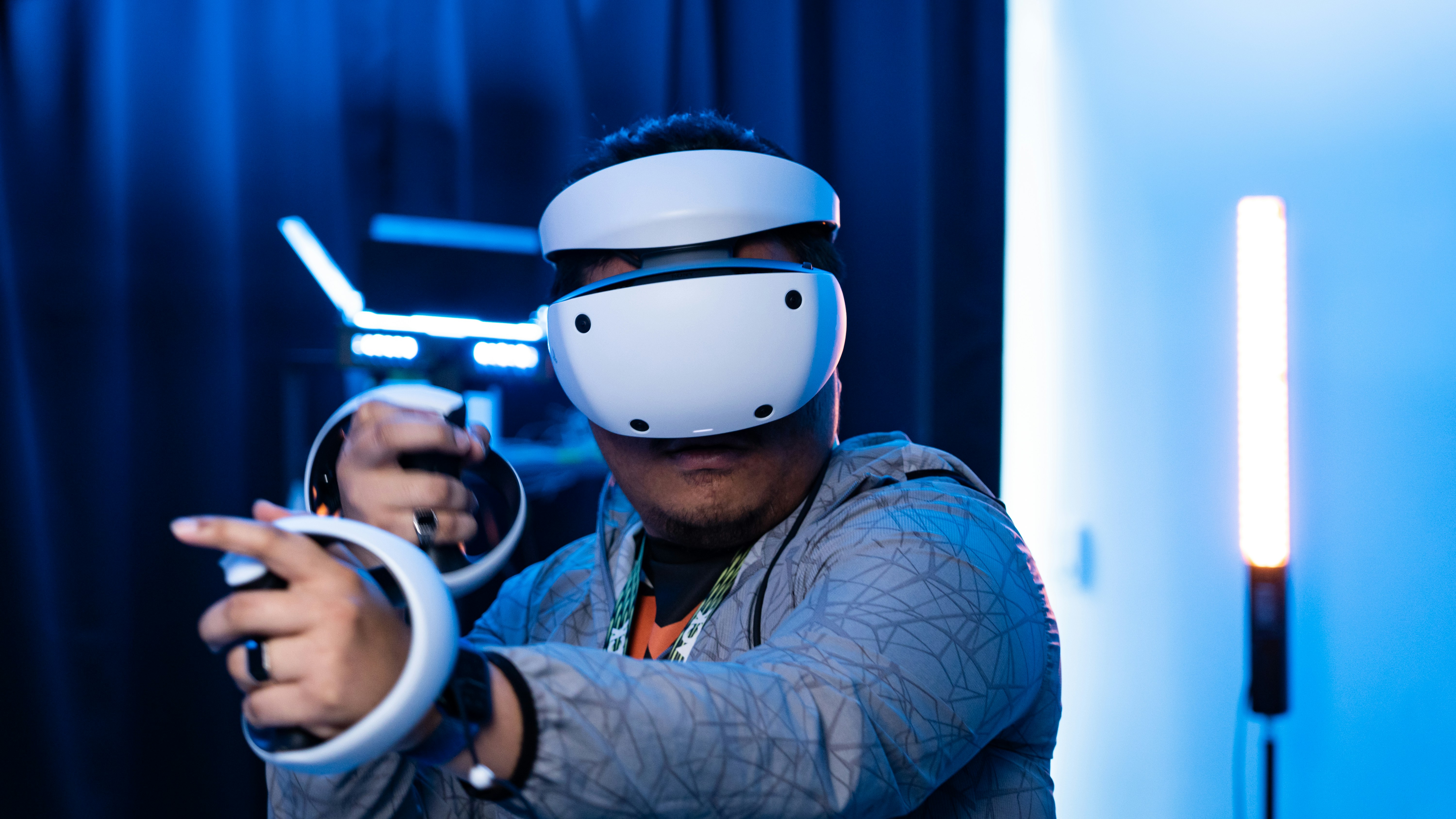 A man wearing a helmet and holding a video game controller