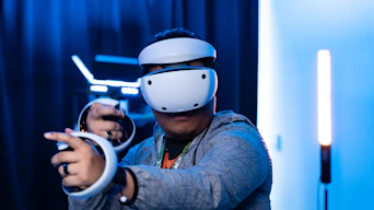 A man wearing a helmet and holding a video game controller
