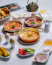 A table topped with lots of different types of food