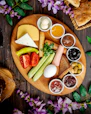 A wooden plate topped with different types of food