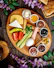 A wooden plate topped with different types of food
