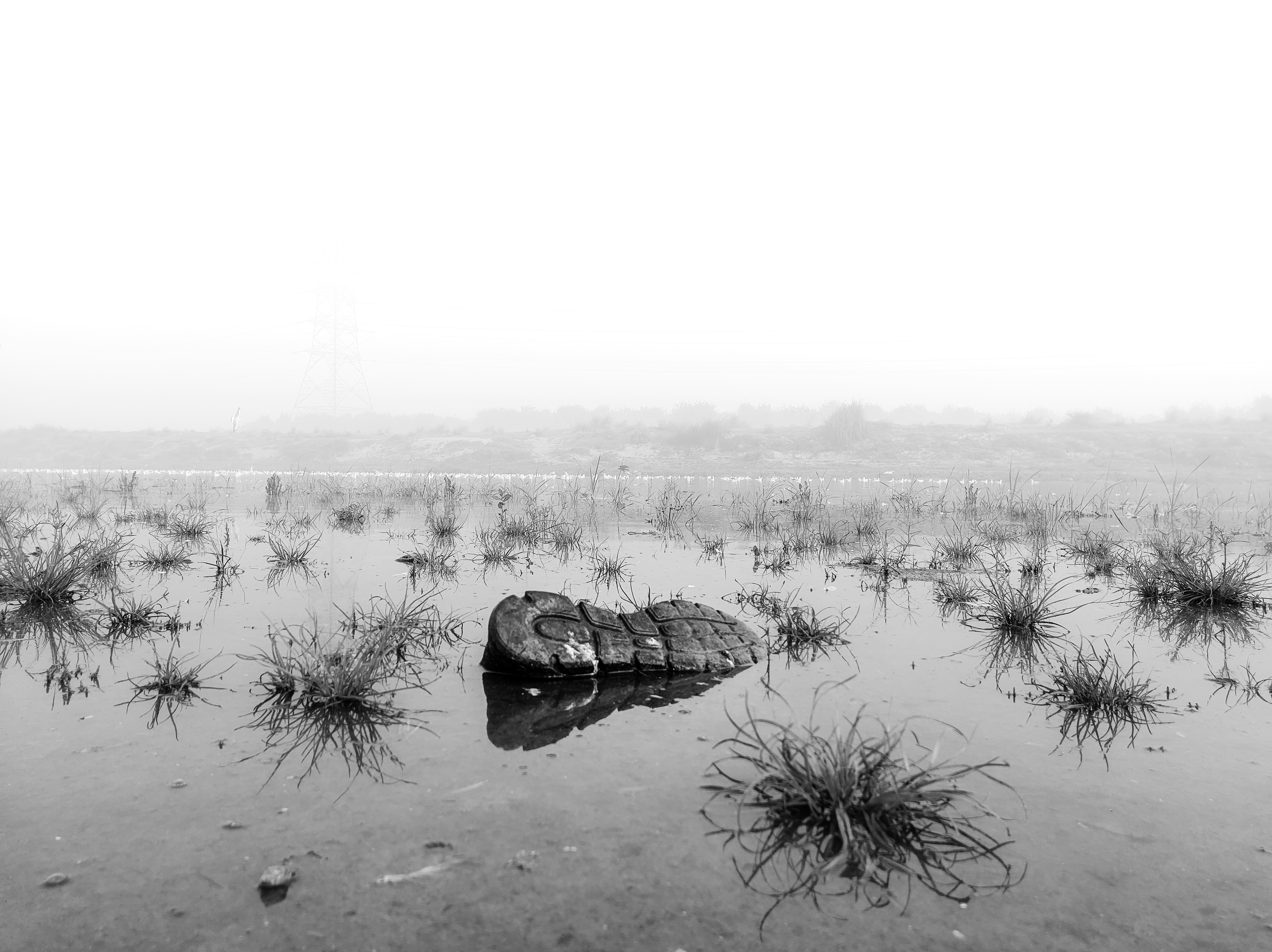 A black and white photo of a boat in a body of water