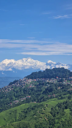 A view of a mountain range with snow capped mountains in the distance