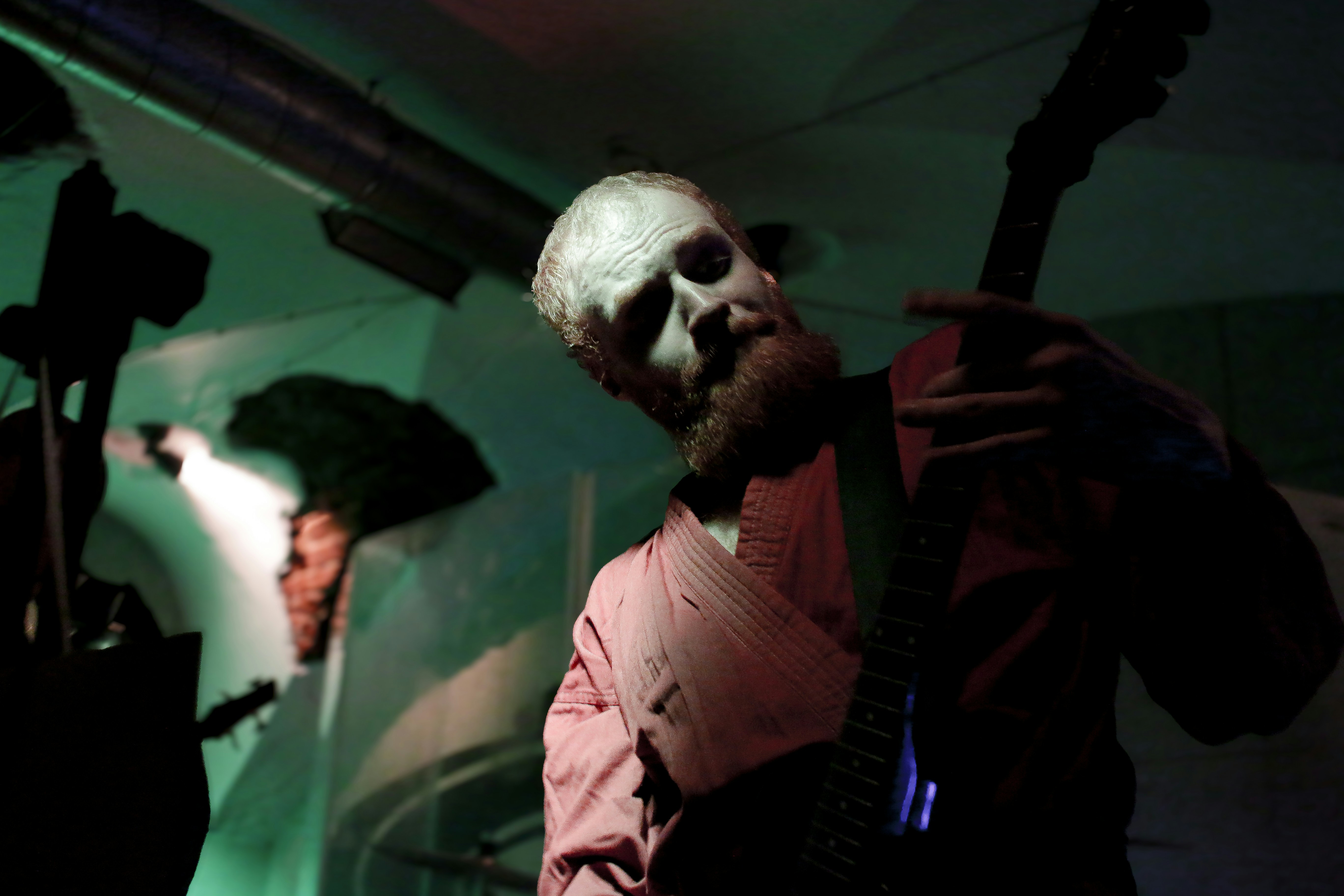 A man with a creepy face and a backpack
