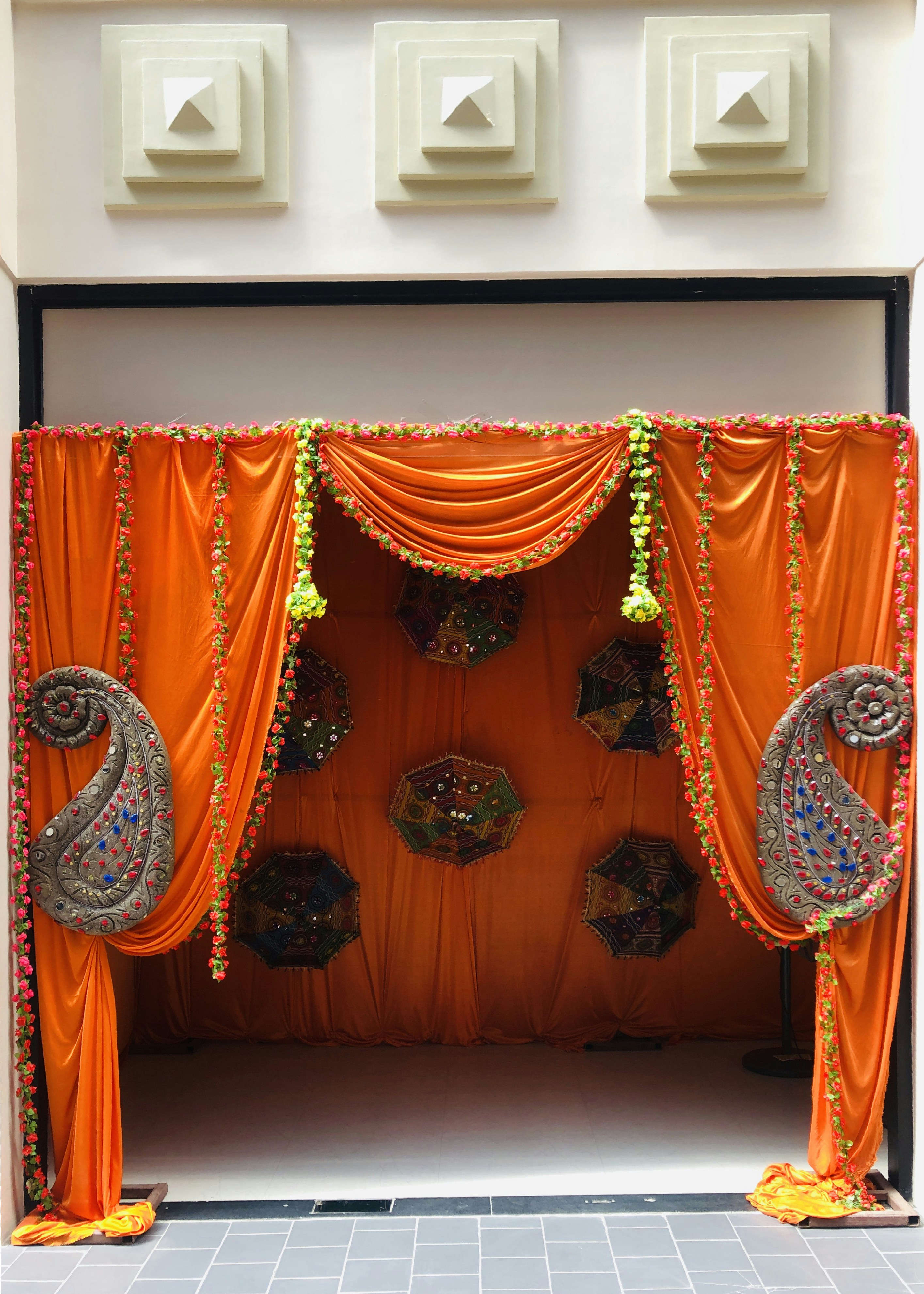Un escenario decorado con cortinas y decoraciones naranjas