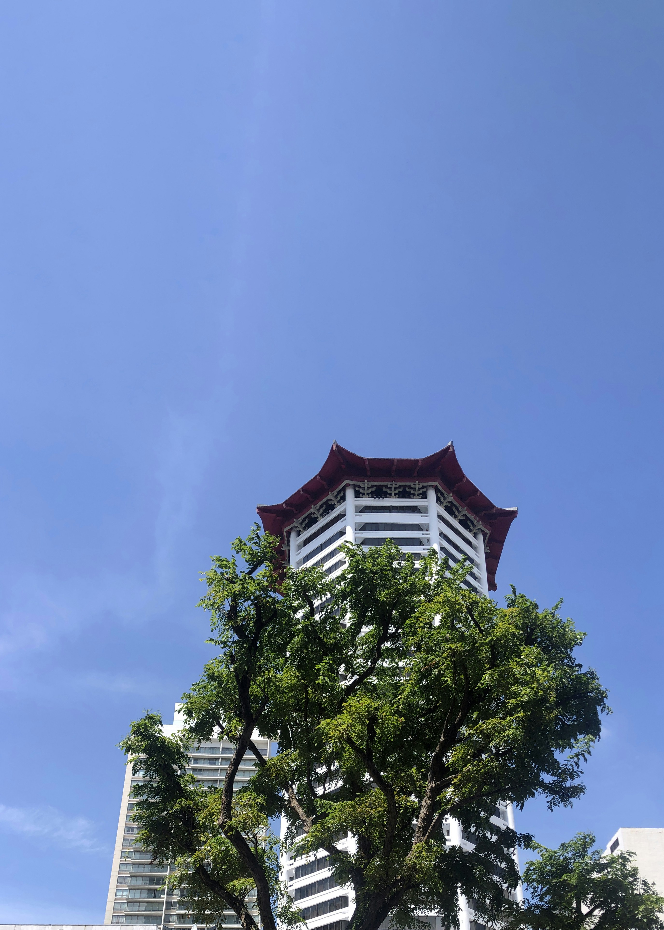 A tall white building with a red roof