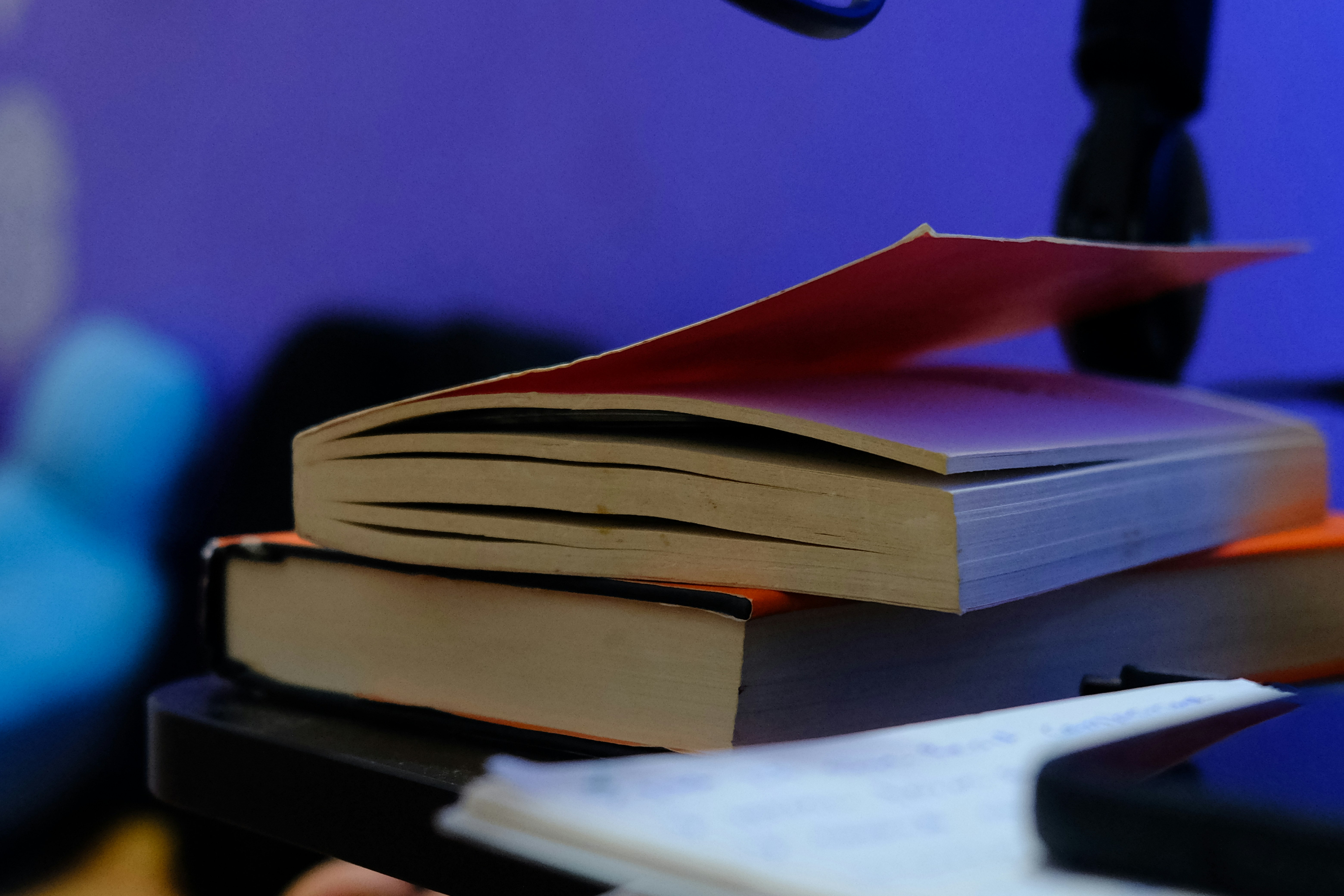 A stack of books sitting on top of a desk