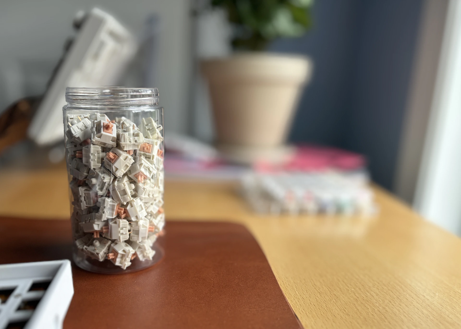 A jar filled with candy sitting on top of a wooden table