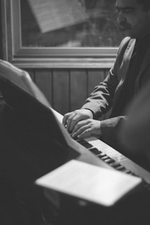A man sitting in front of a keyboard