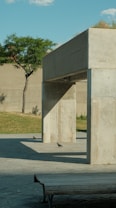 A concrete structure with a bench in front of it