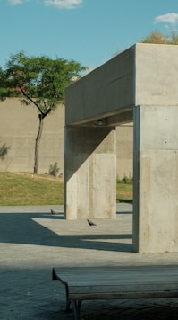A concrete structure with a bench in front of it