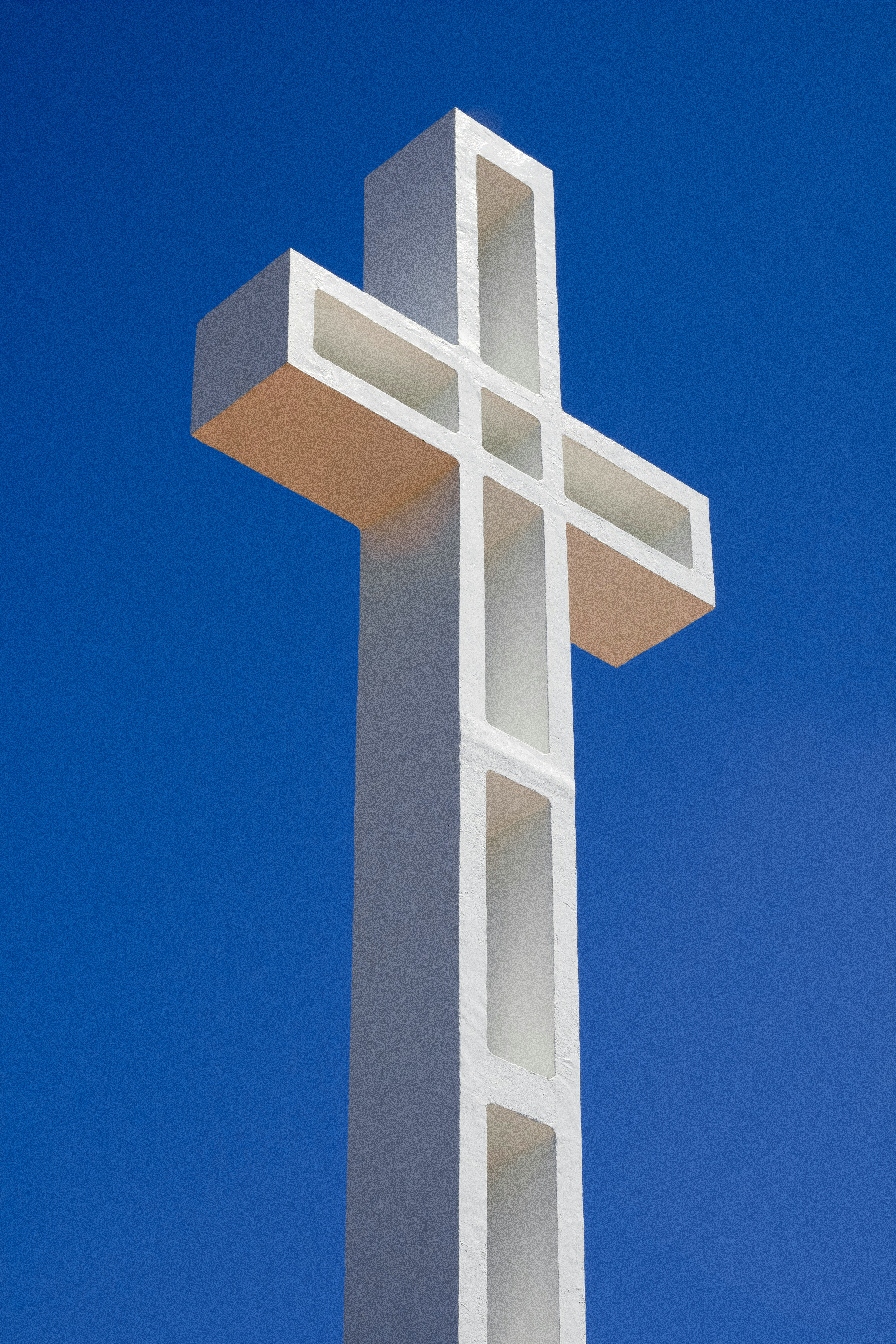 A large white cross on top of a building